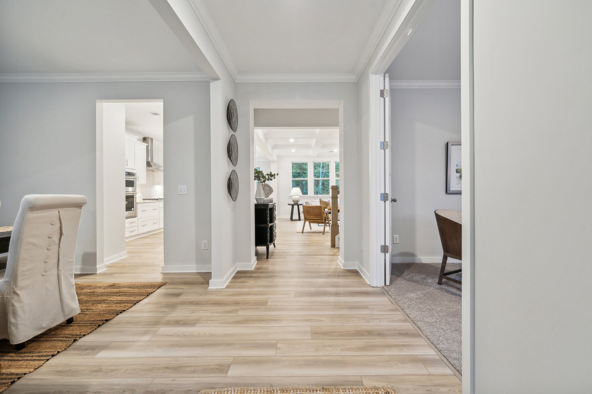 A room with a wood floor and a rug and a wood floor.
