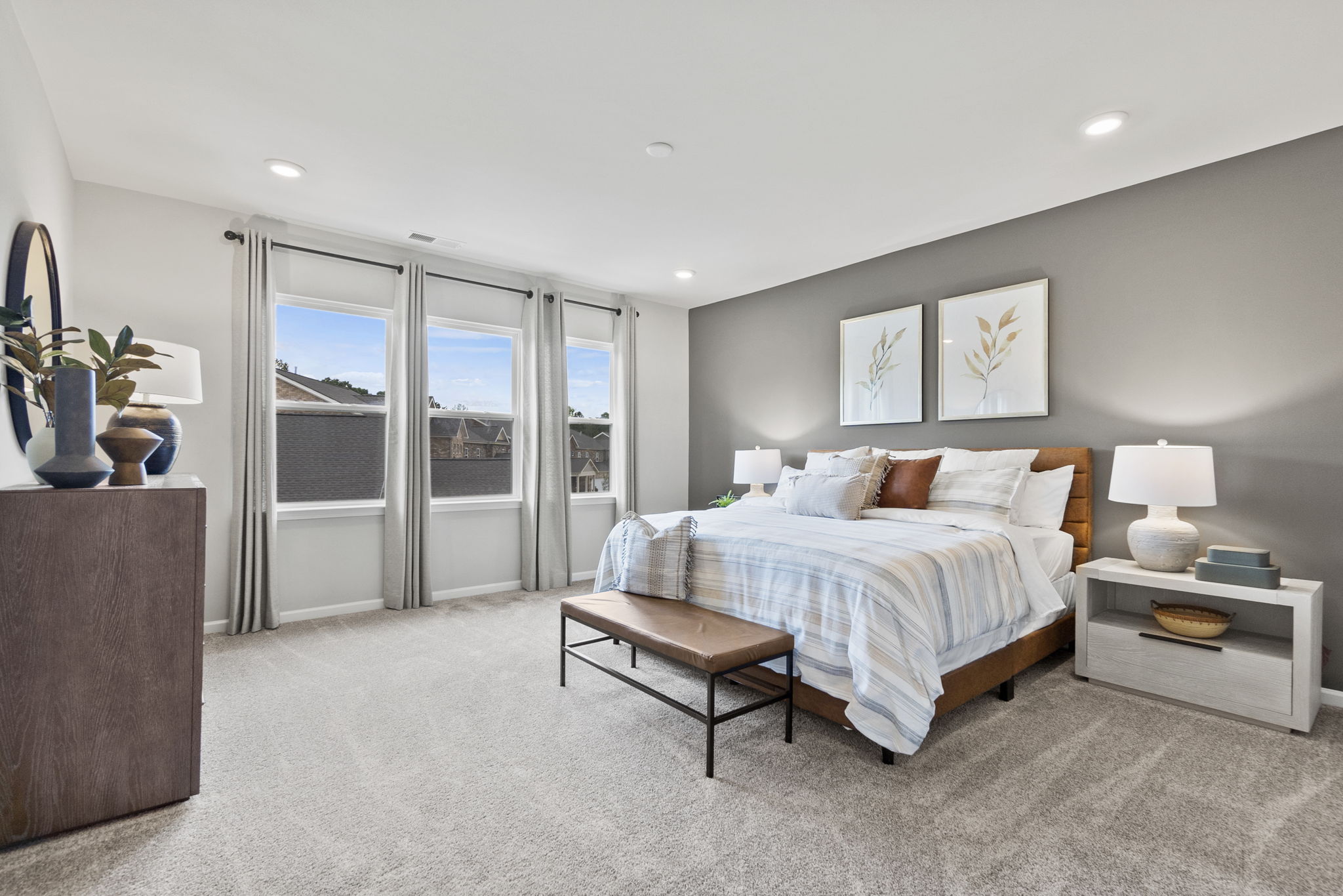 A bedroom with a bed and a table.