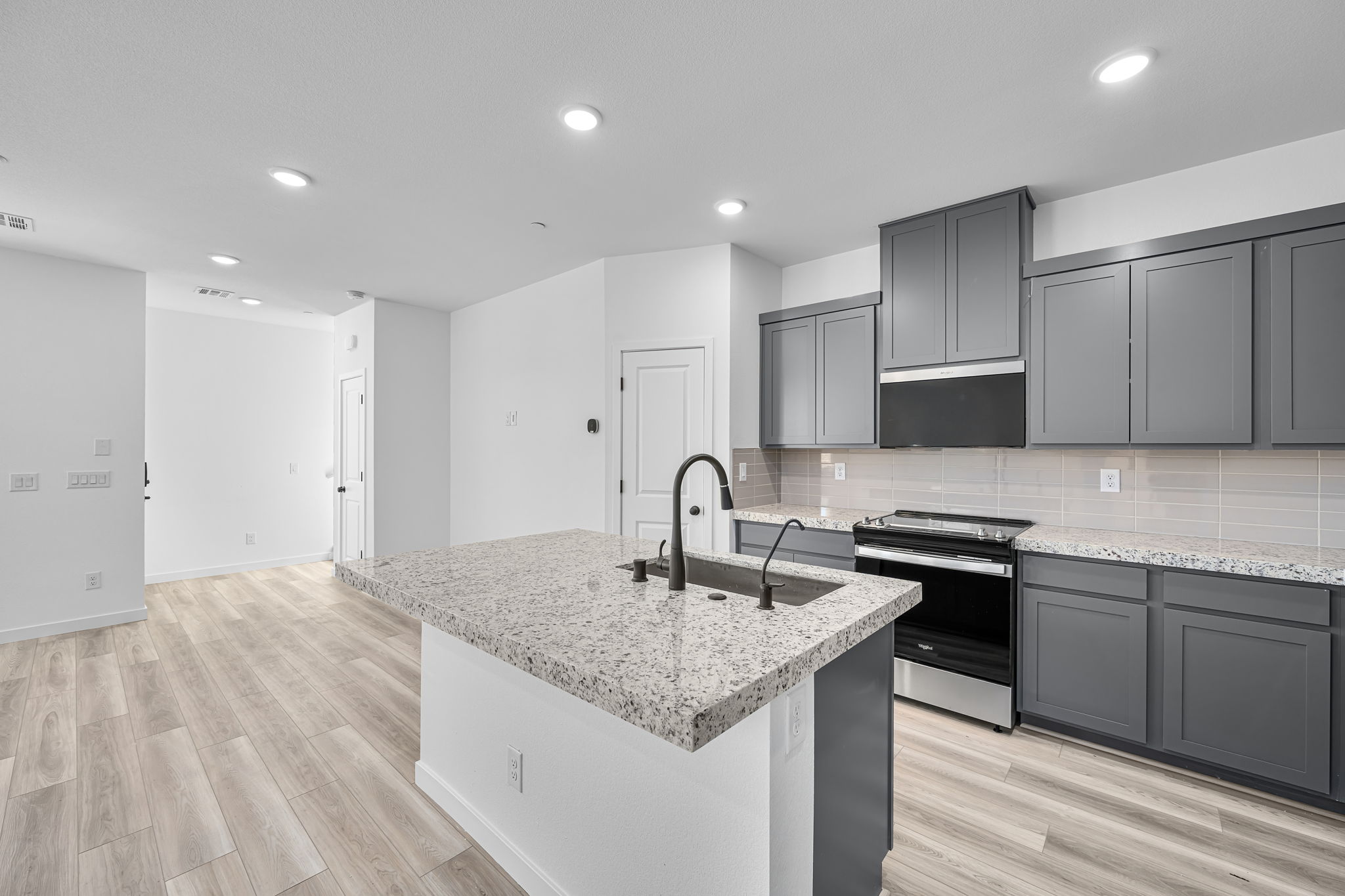 A kitchen with black cabinets.