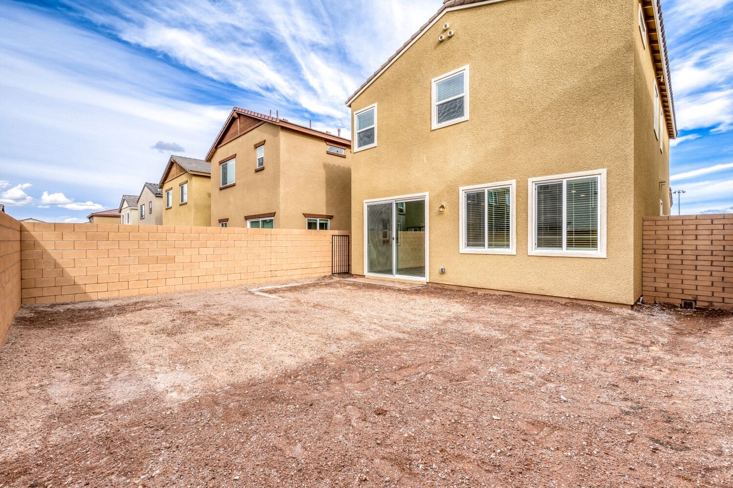 A building with a dirt yard.