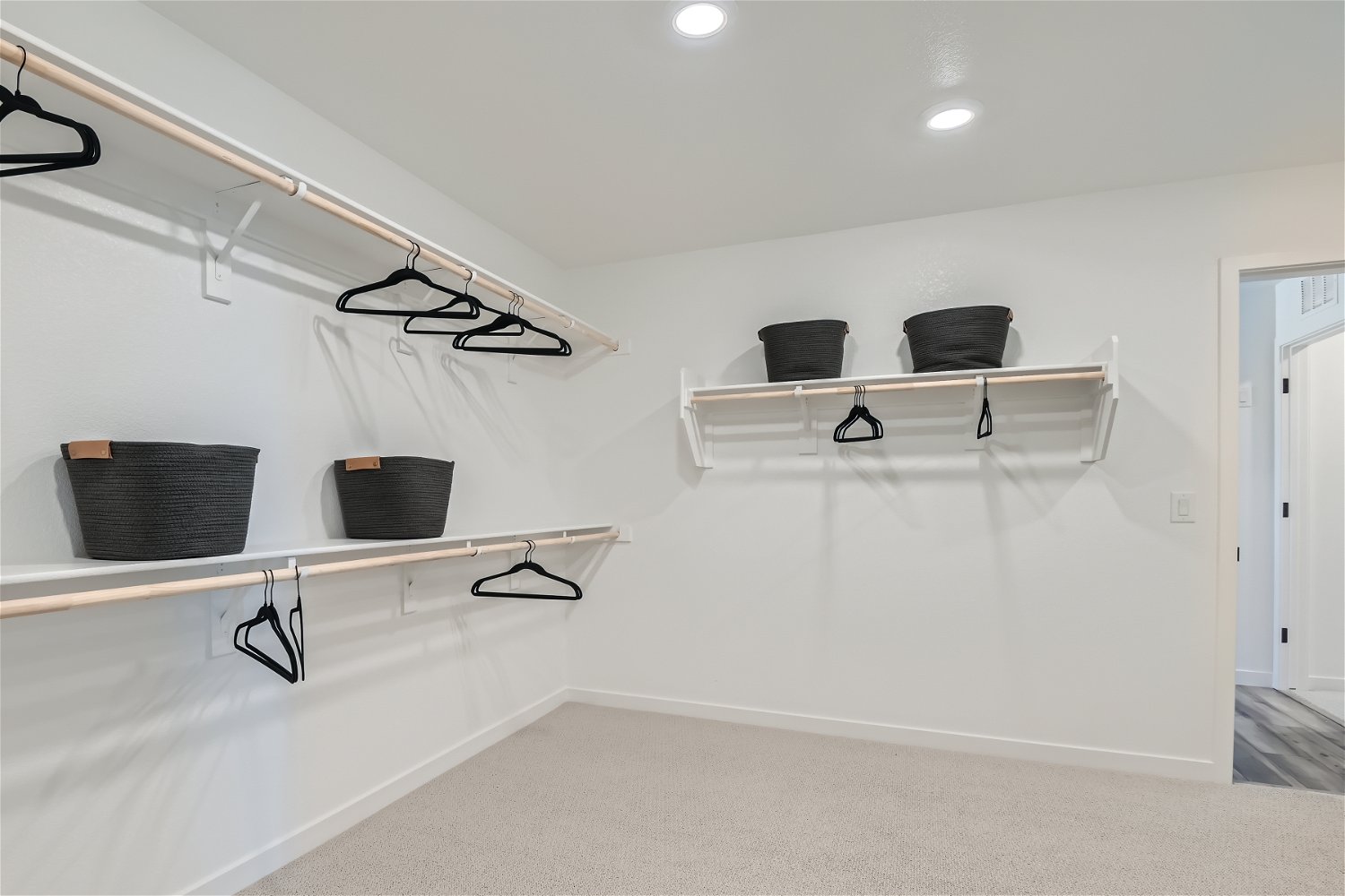 A white room with a shelf and a chair.