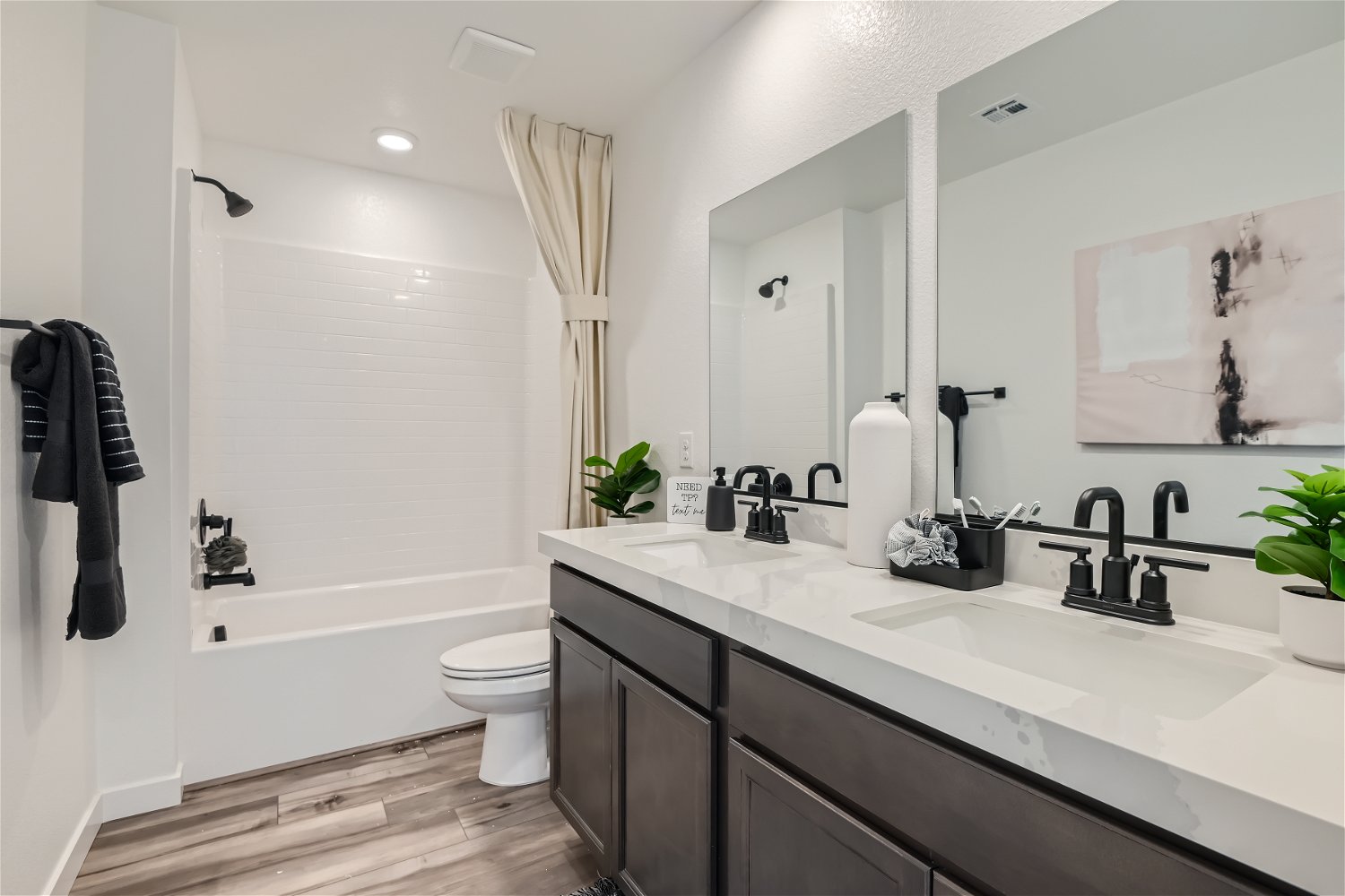 A bathroom with a tub sink and toilet.