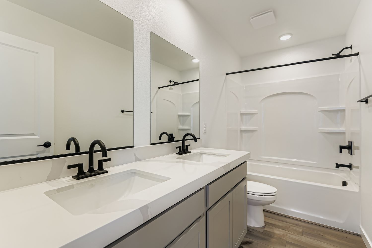 A bathroom with a tub sink and toilet.
