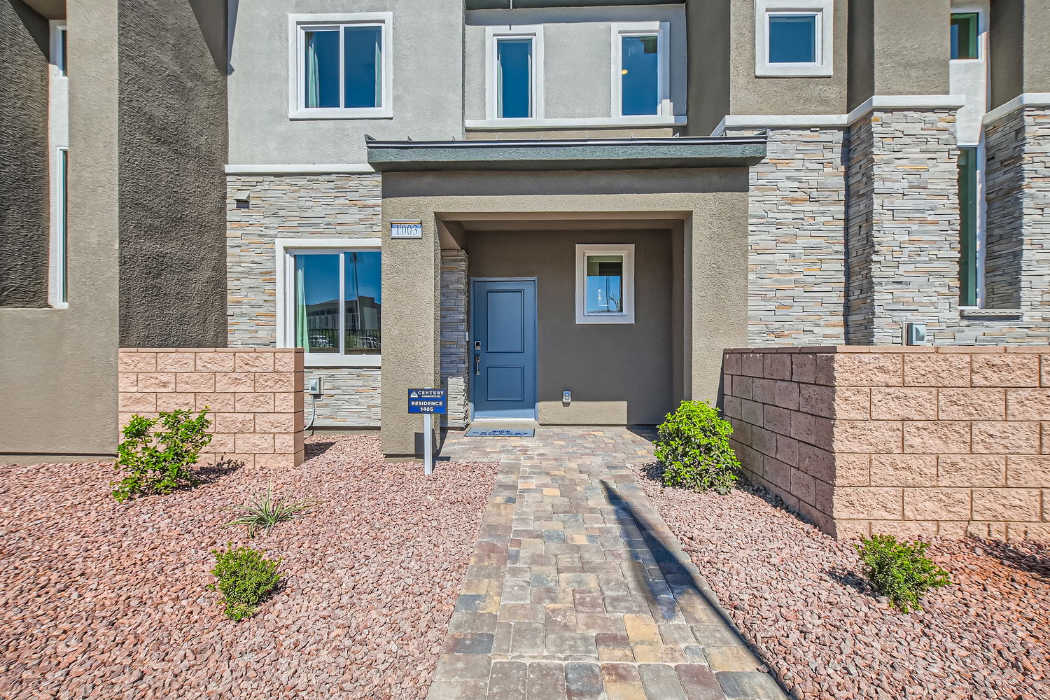 A brick building with a blue door.