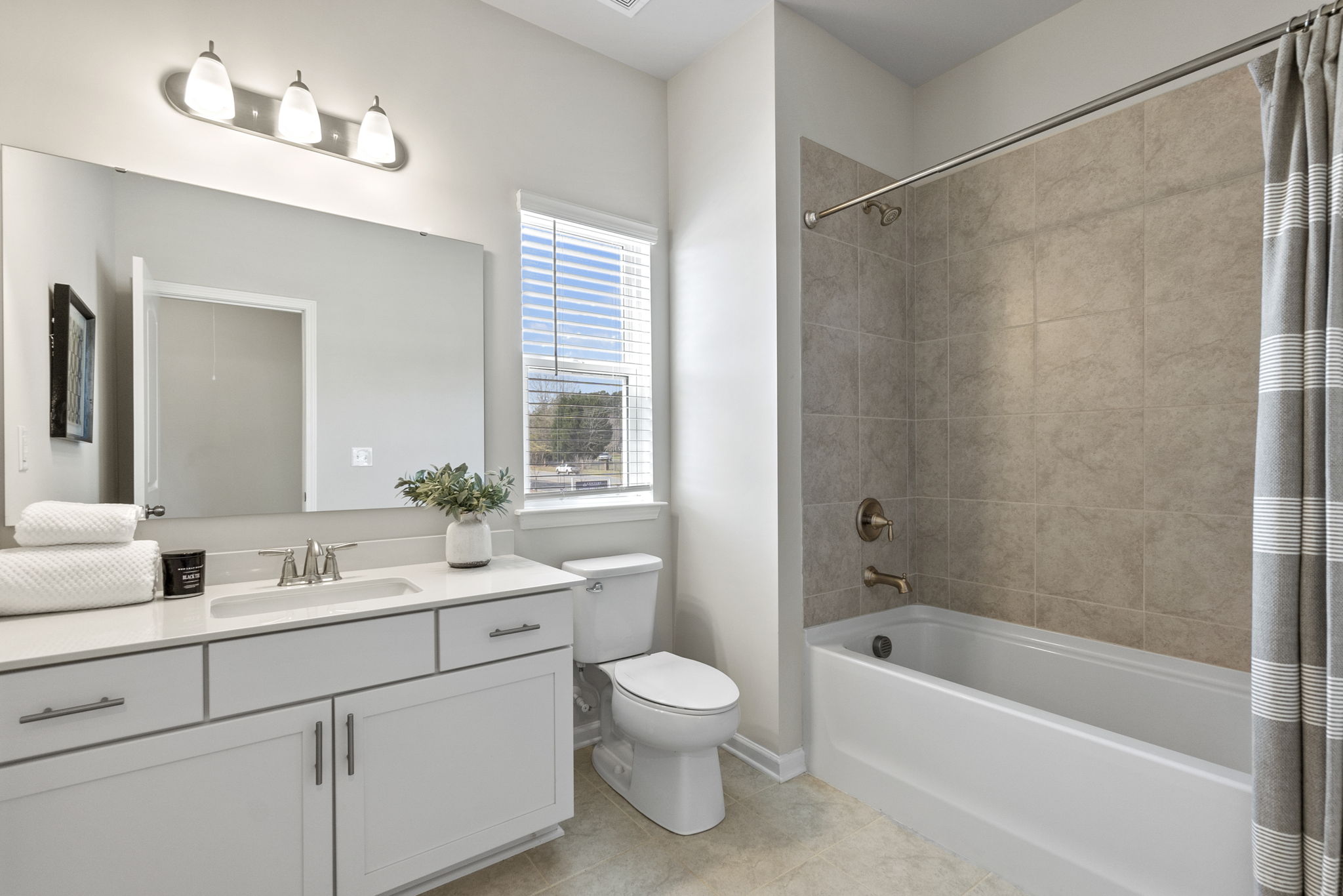 A bathroom with a tub toilet and sink.