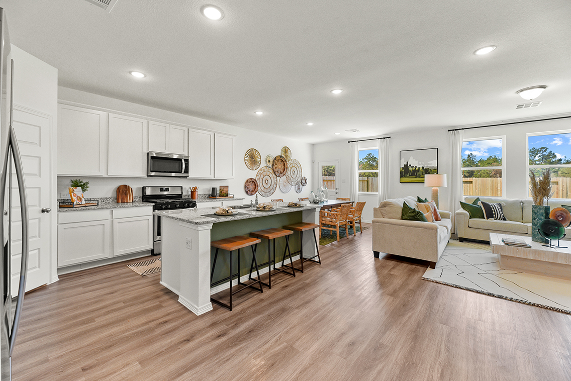 A kitchen with white cabinets.