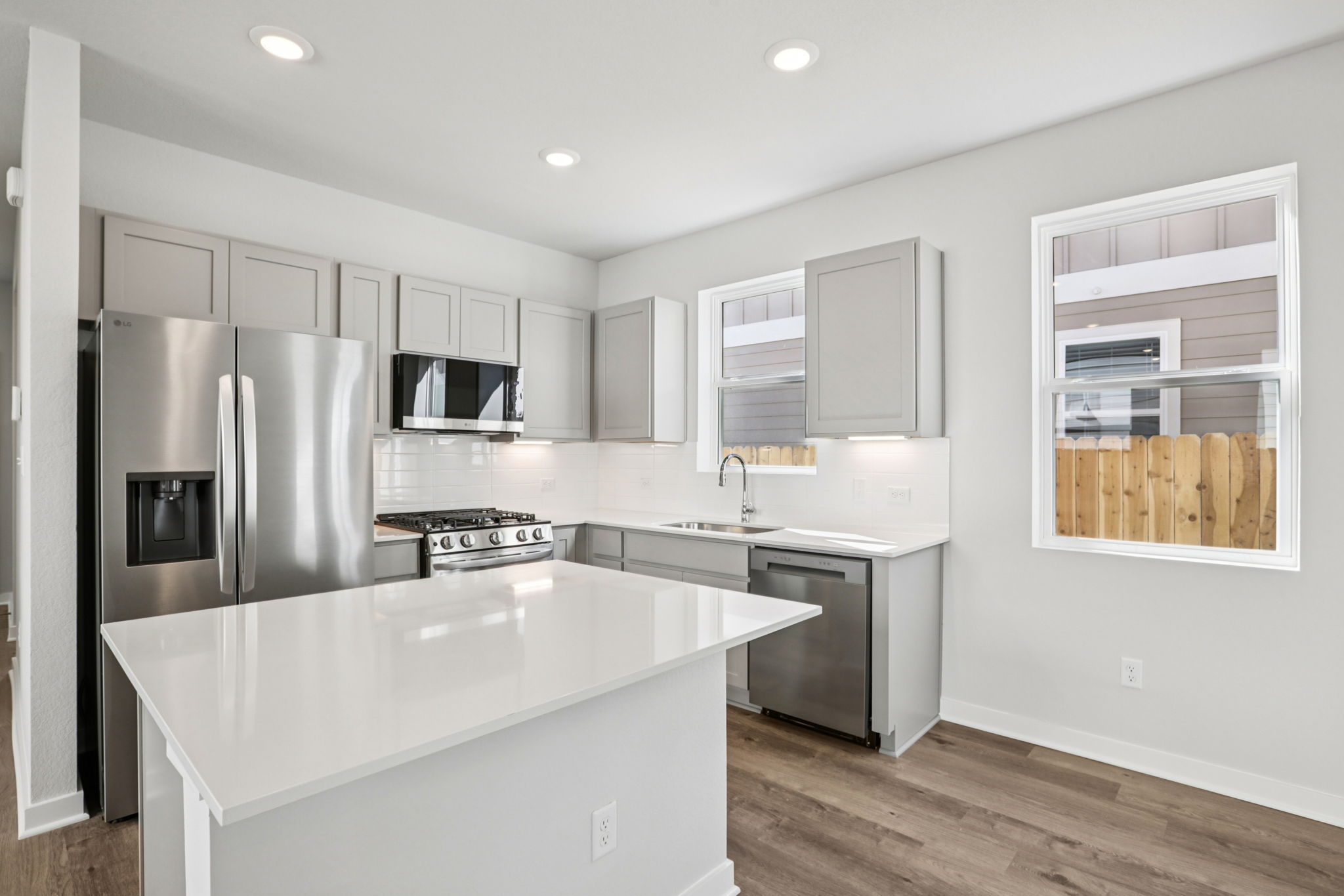 A kitchen with white cabinets.