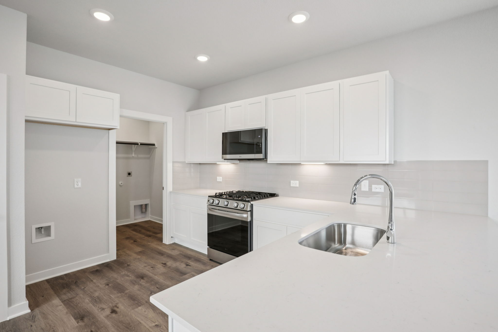 A kitchen with white cabinets.