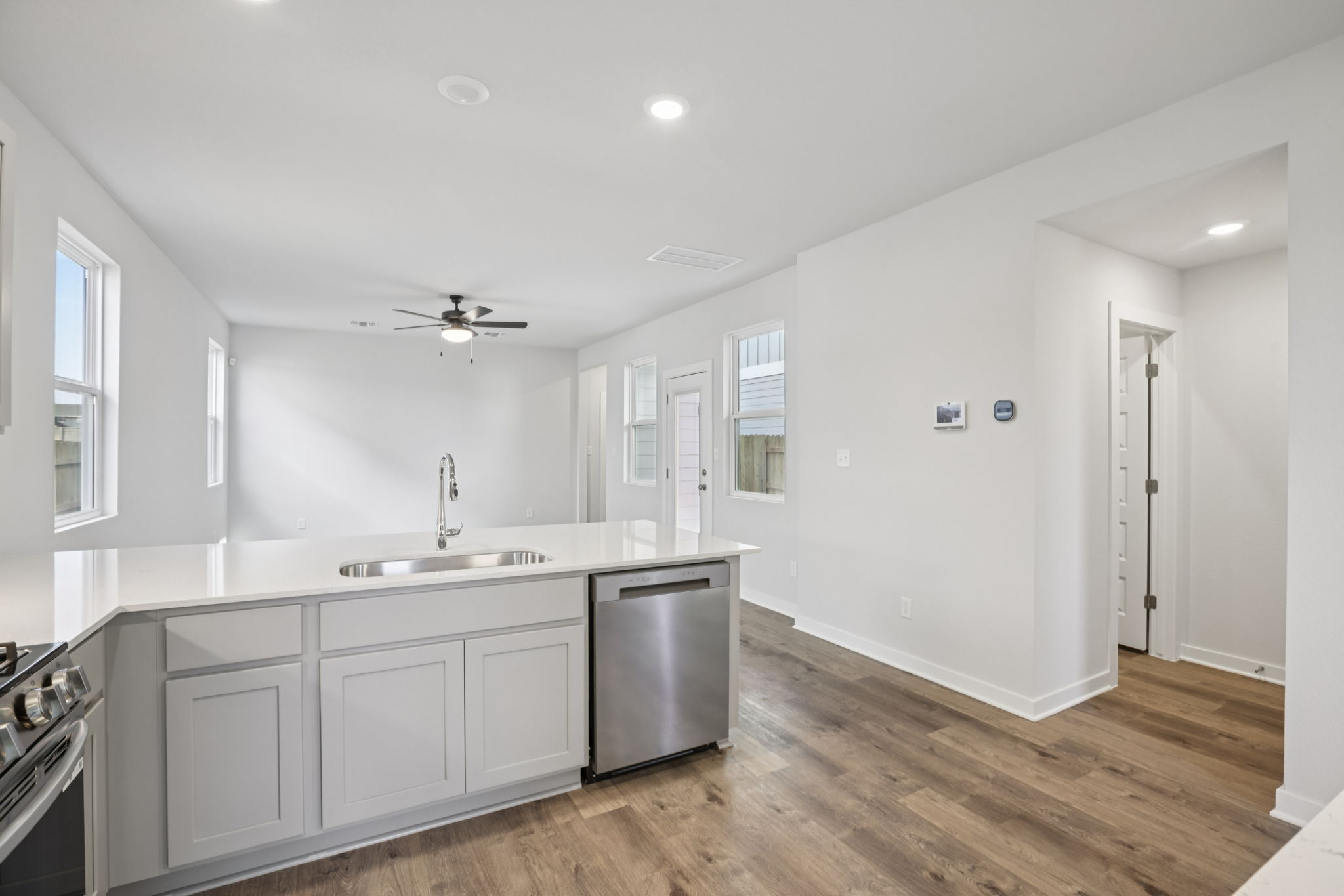 A kitchen with white cabinets.