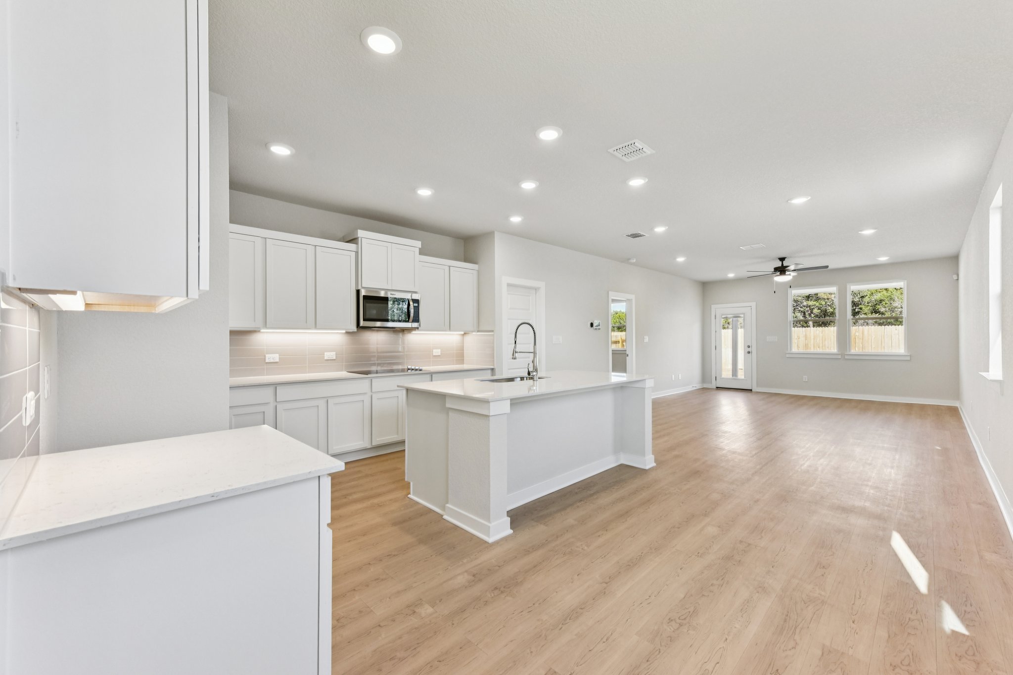 A kitchen with white cabinets.