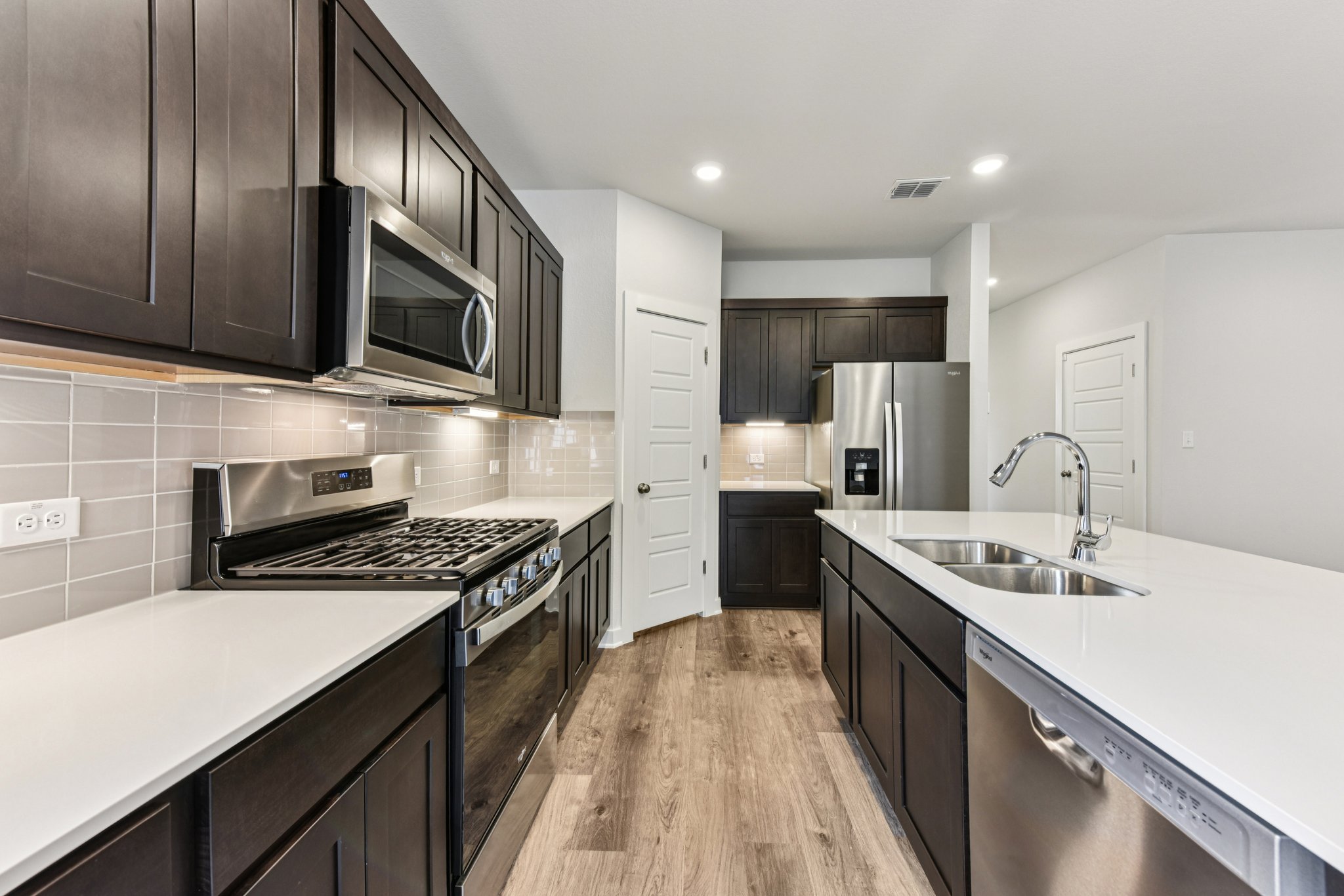 A kitchen with black cabinets.