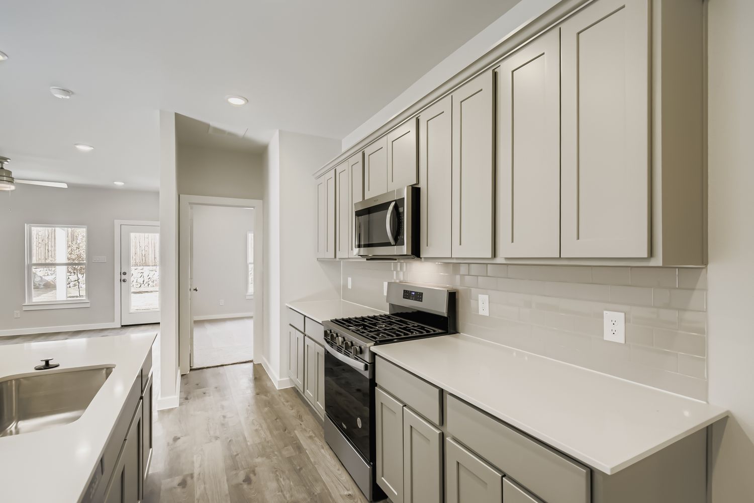 A kitchen with white cabinets.