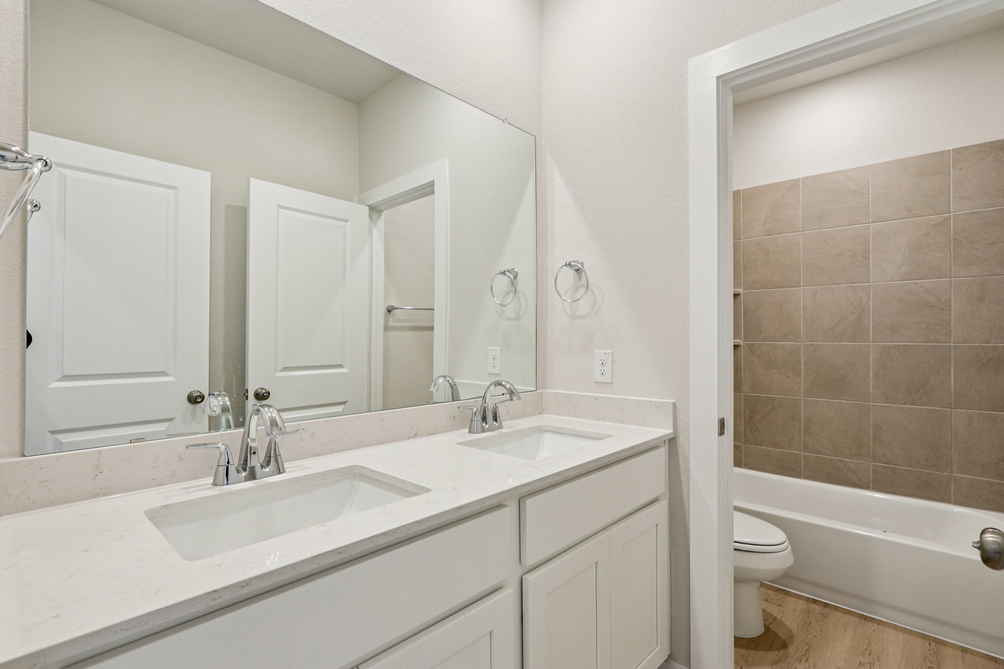 A bathroom with a tub sink and toilet.