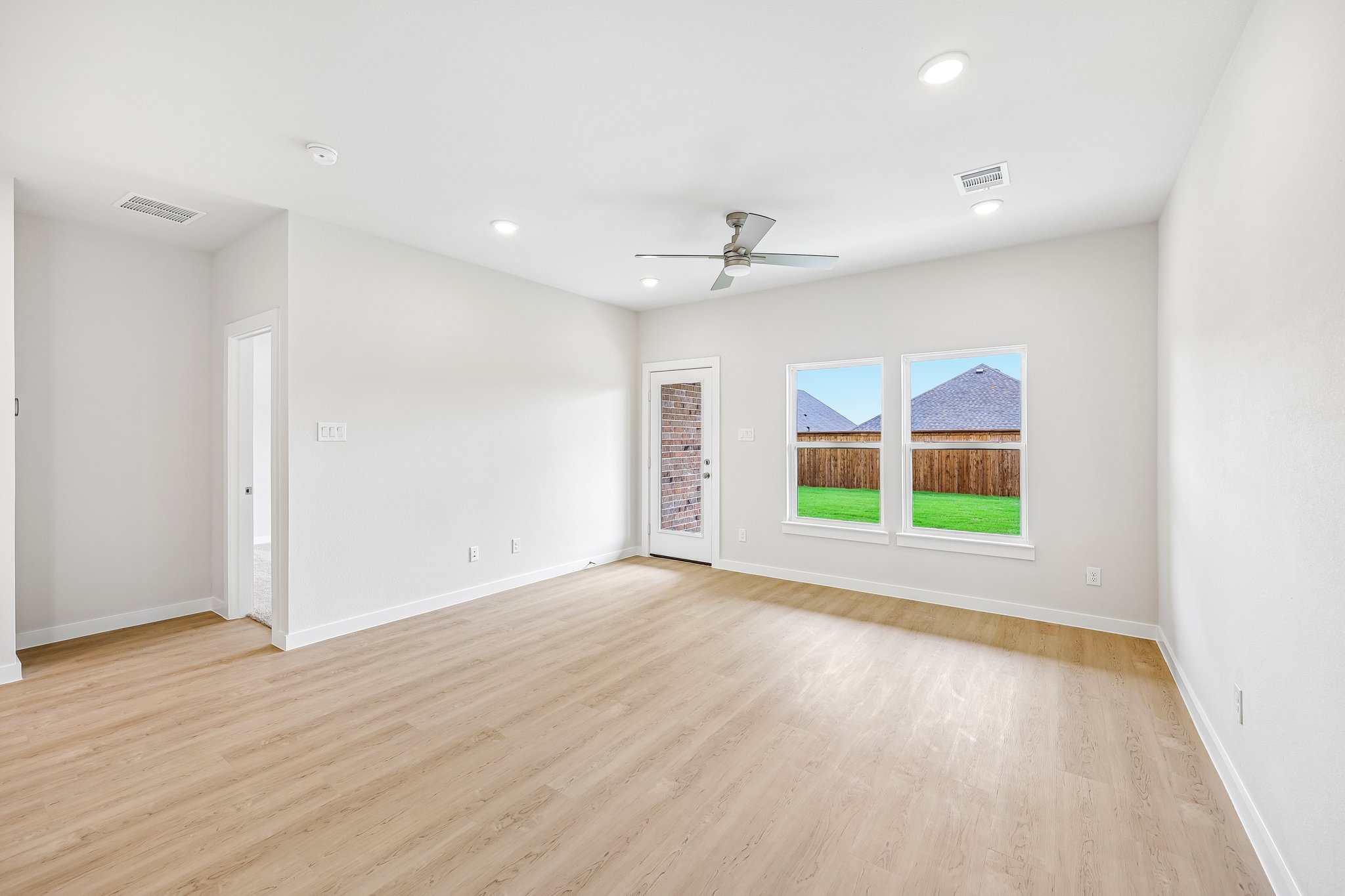A room with a wood floor and a wood floor with a painting on the wall.