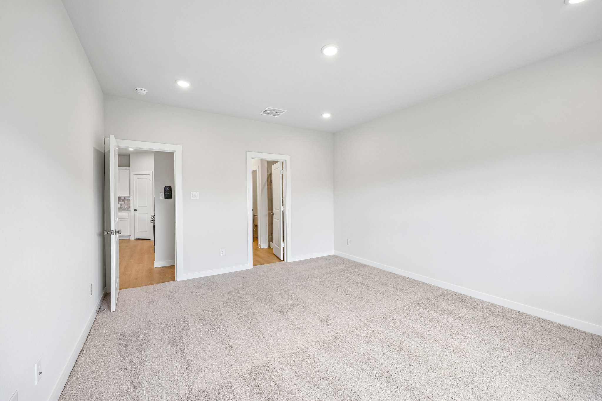 A hallway with white walls.