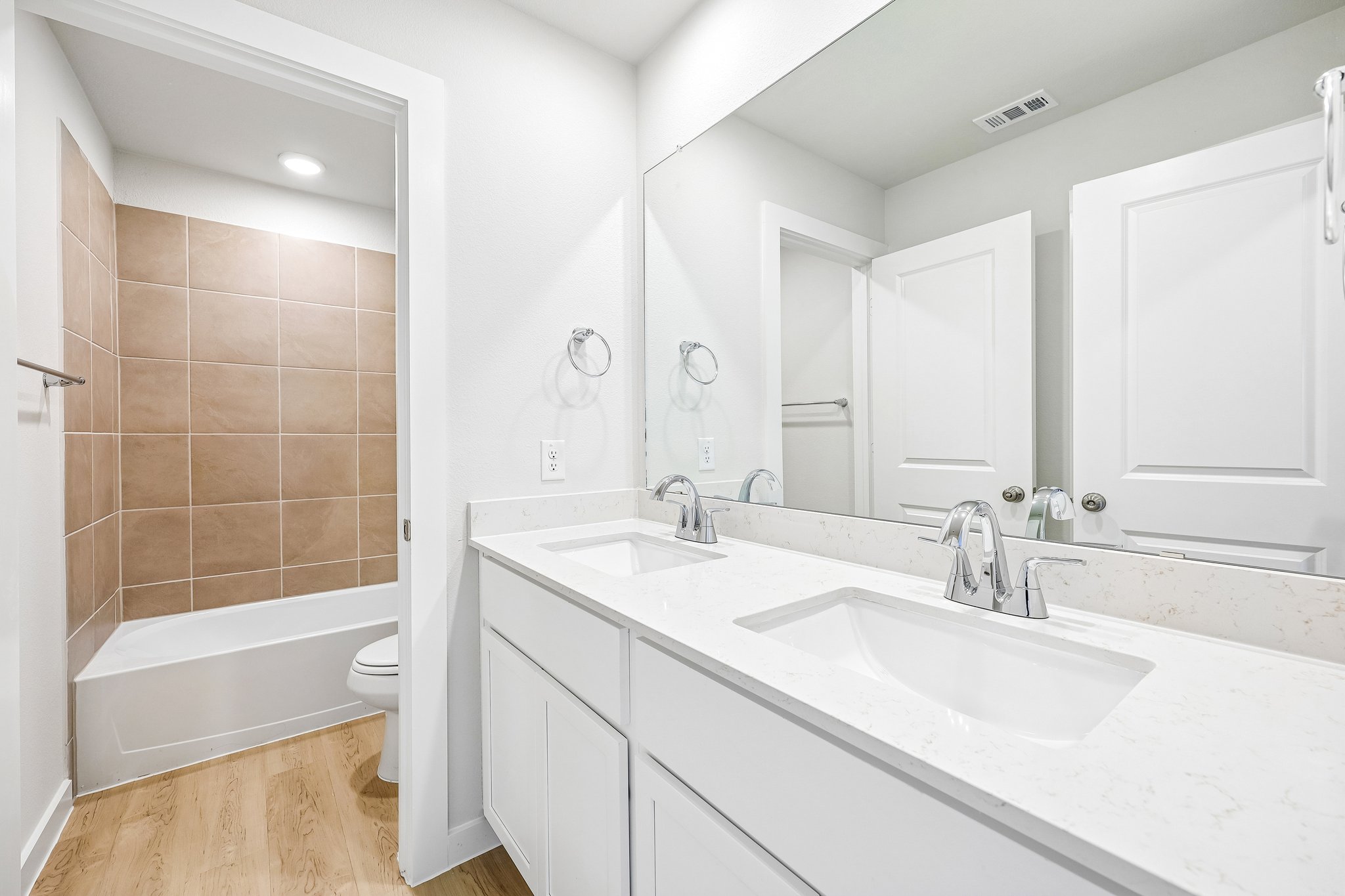 A bathroom with a tub sink and toilet.