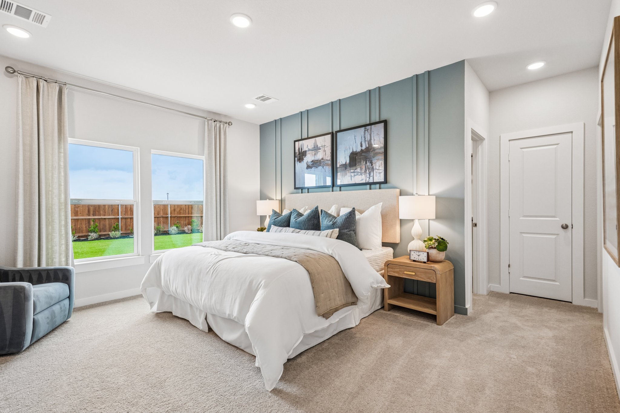 A bedroom with a large window.