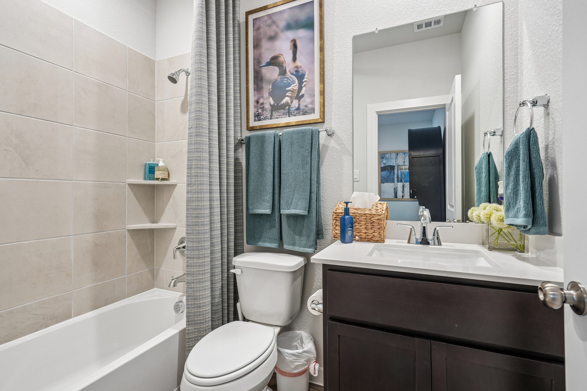 A bathroom with a tub toilet and sink.