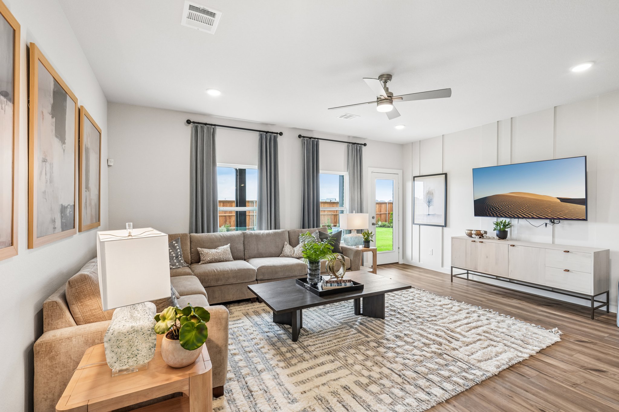 A living room with a large rug.