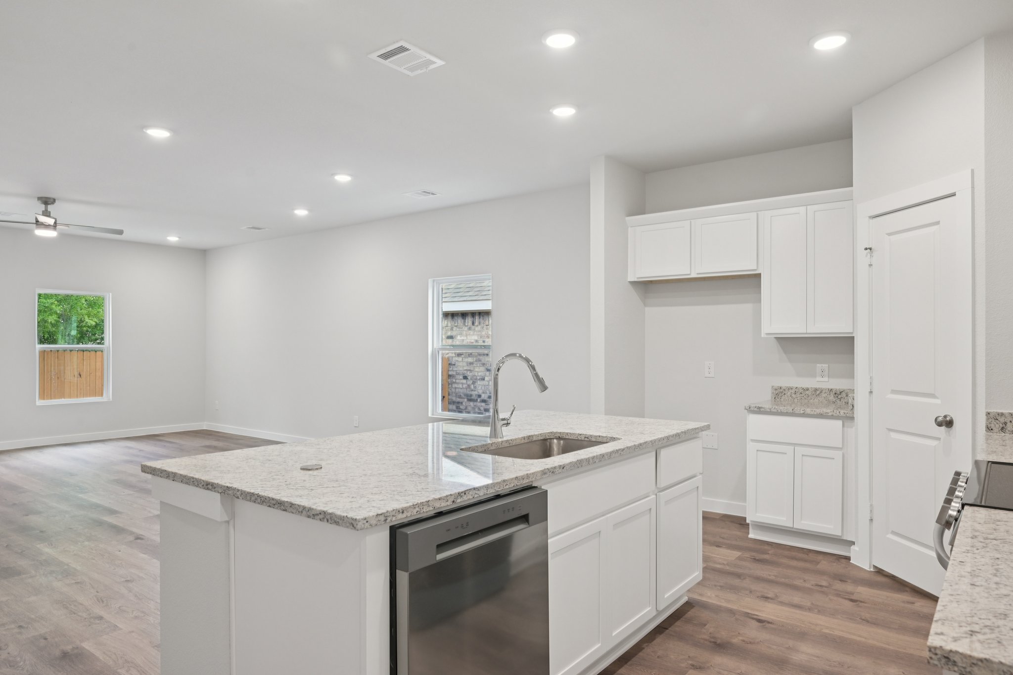A kitchen with white cabinets.