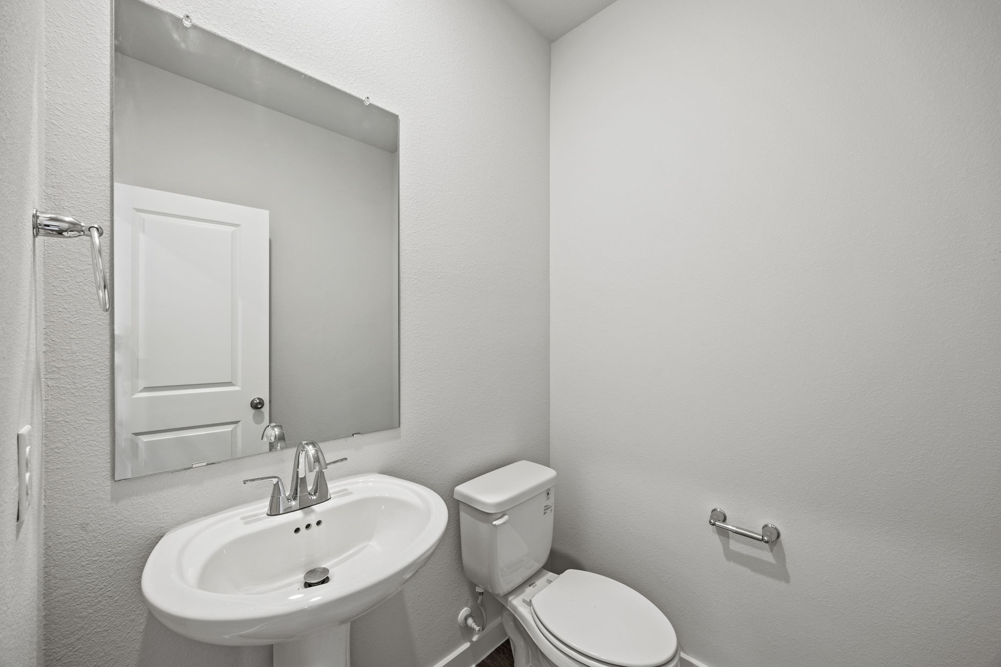 A bathroom with a toilet and sink.