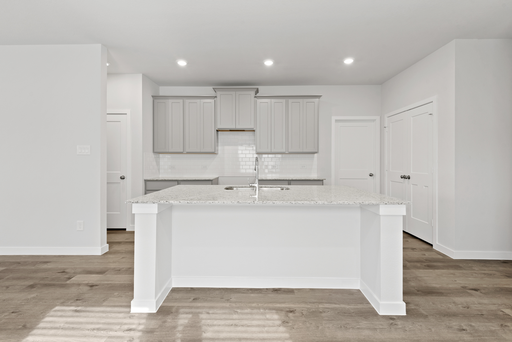 A large white kitchen with white cabinets.
