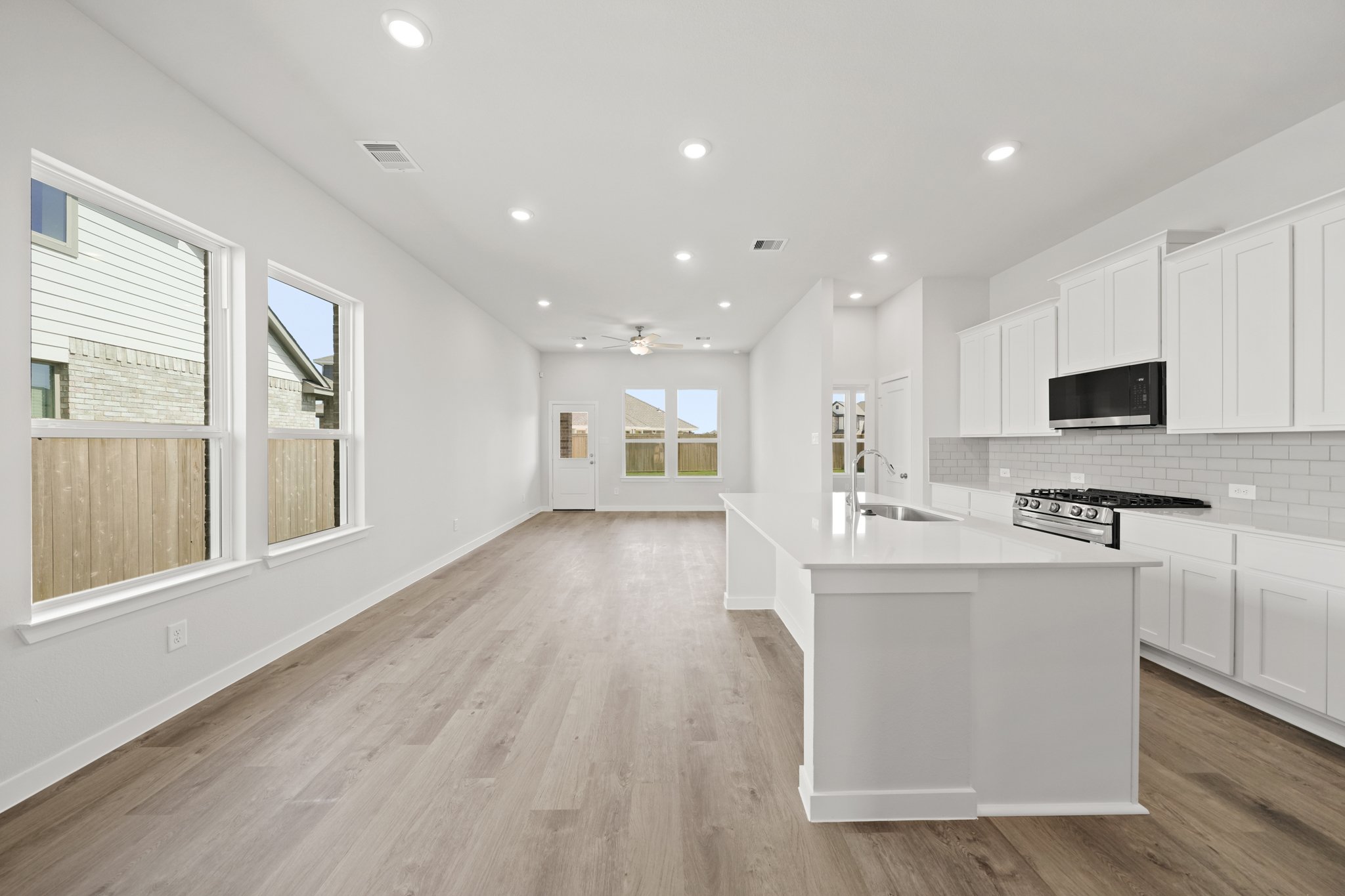 A kitchen with white cabinets.