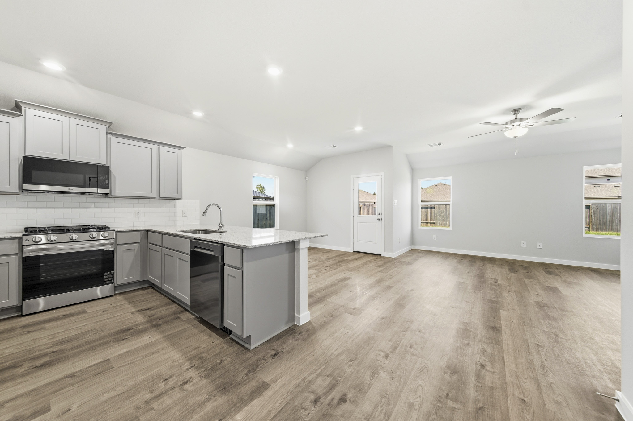 A kitchen with white cabinets.