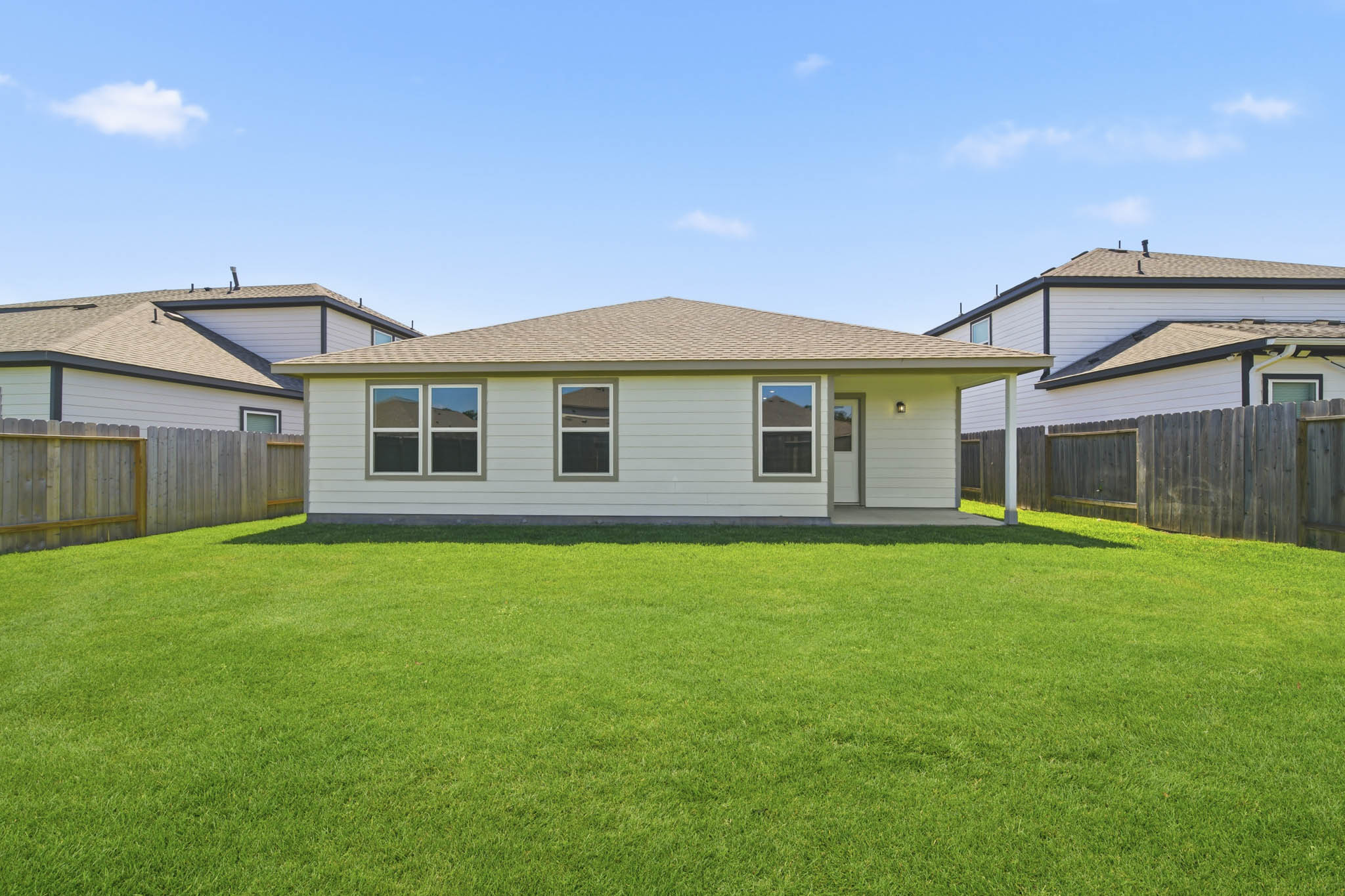 A house with a fence and grass.