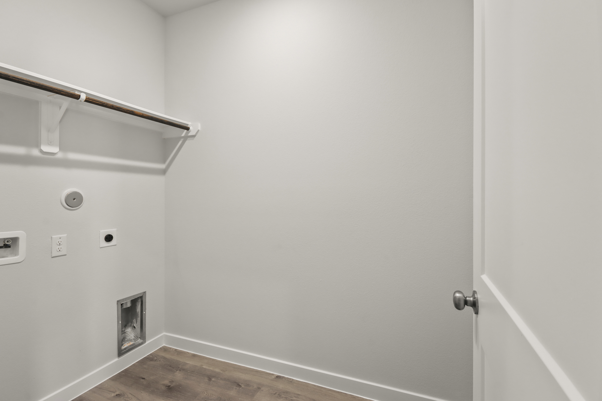 A white door with a metal bar.