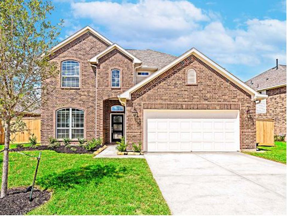 A brick house with a garage.