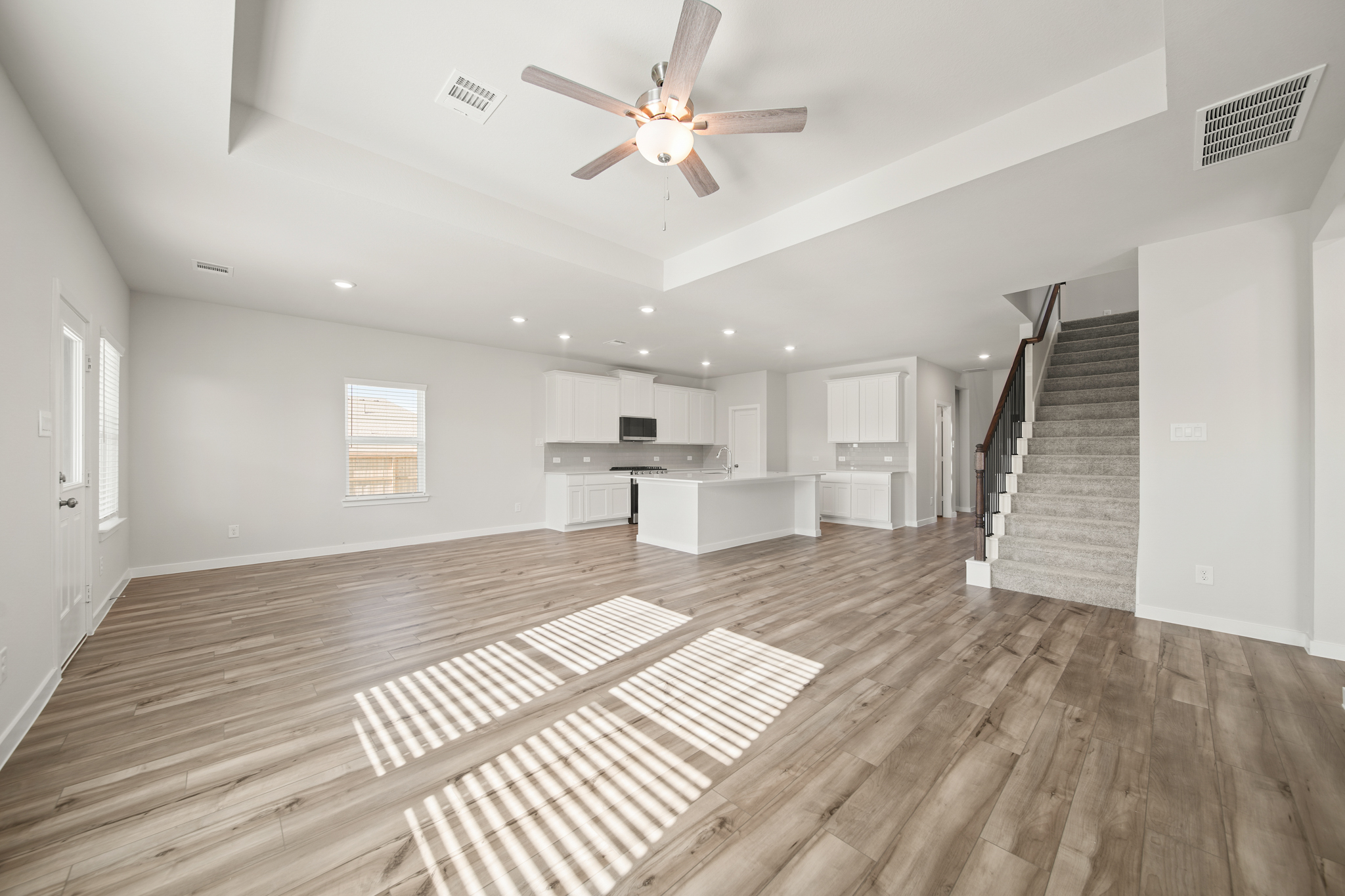 A large empty room with a wood floor and a wood floor.