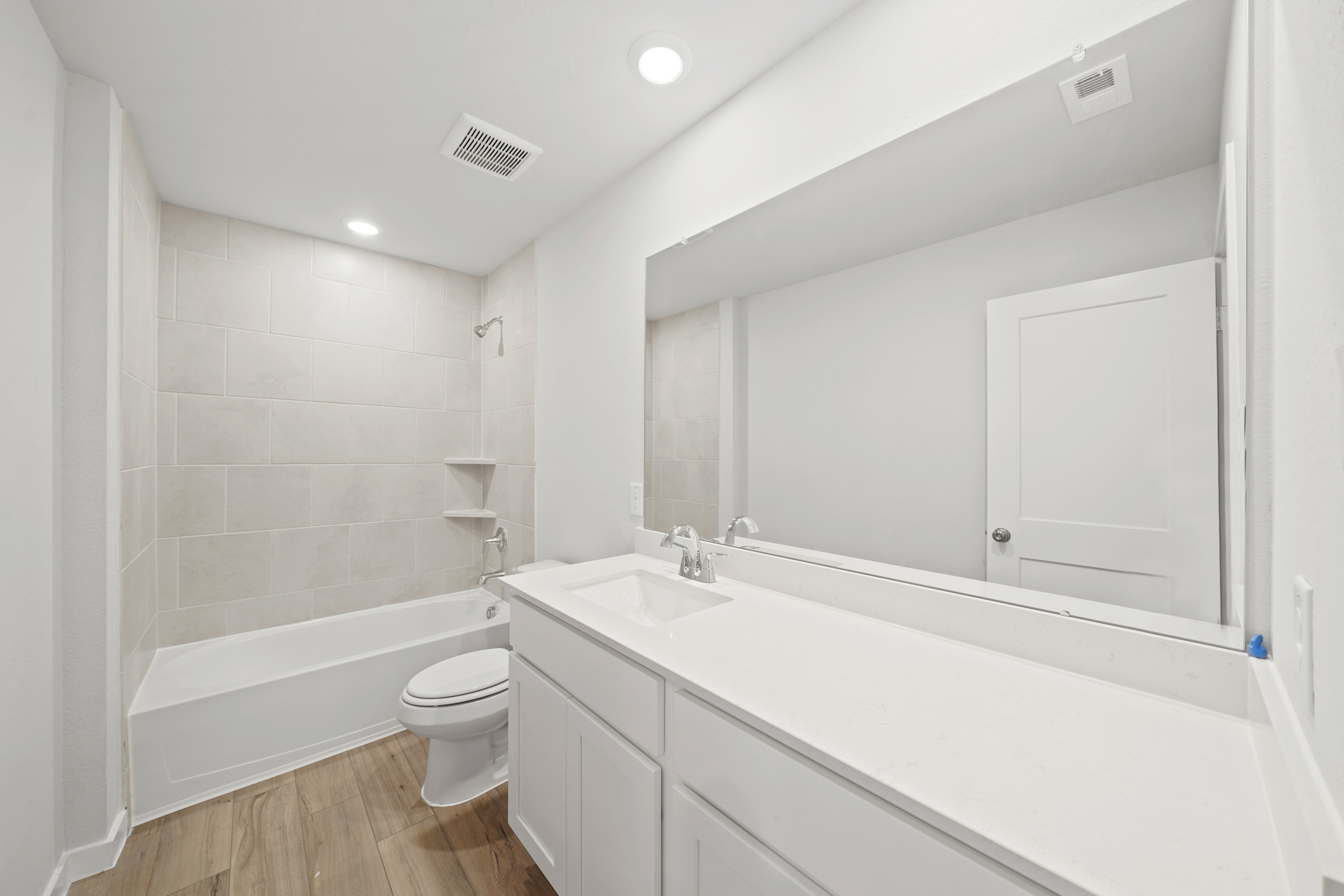 A bathroom with a tub sink and toilet.