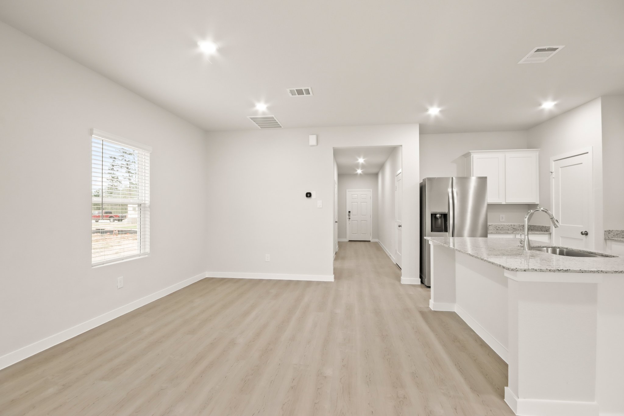 A kitchen with white cabinets.