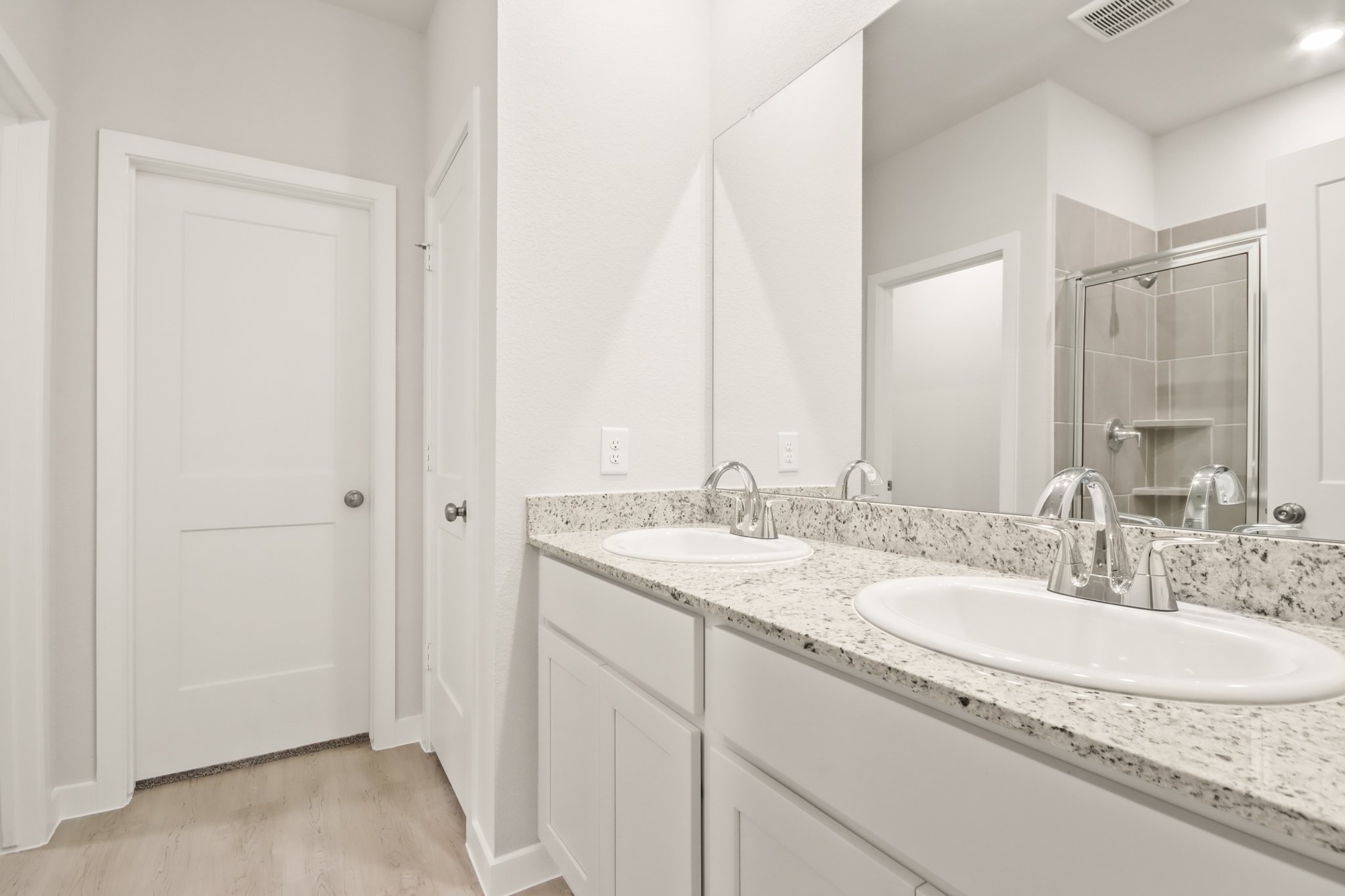 A bathroom with a large mirror.