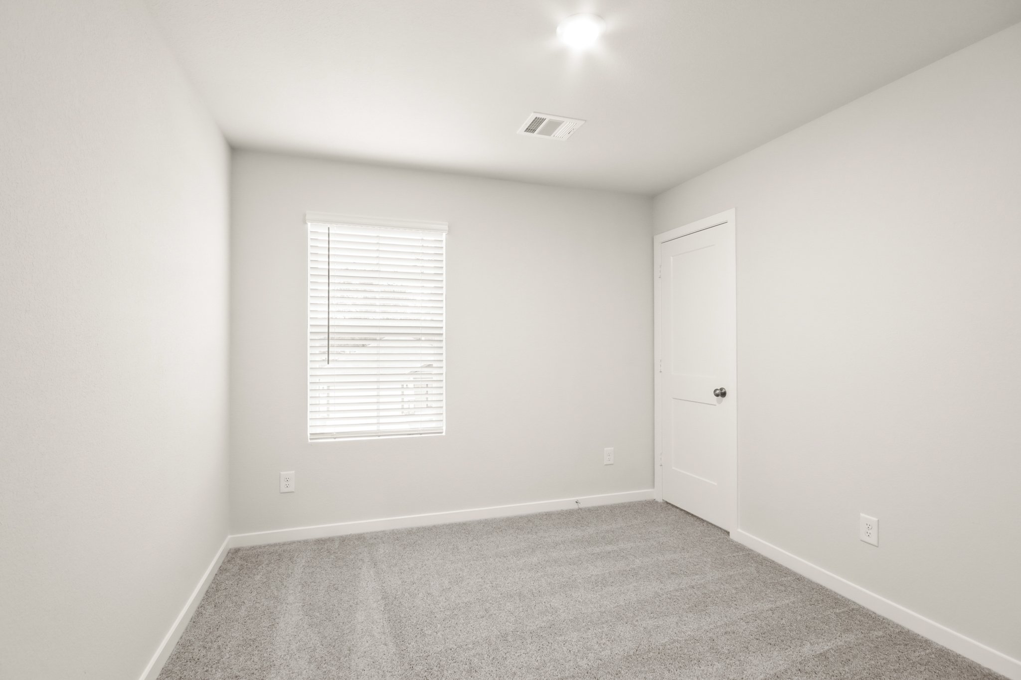 A room with a door and a window.