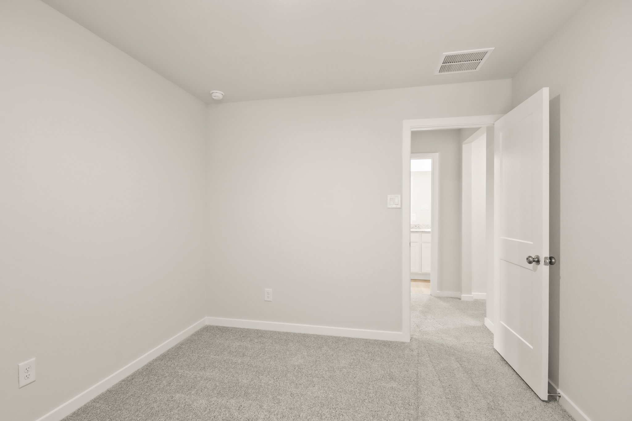 A hallway with white doors.