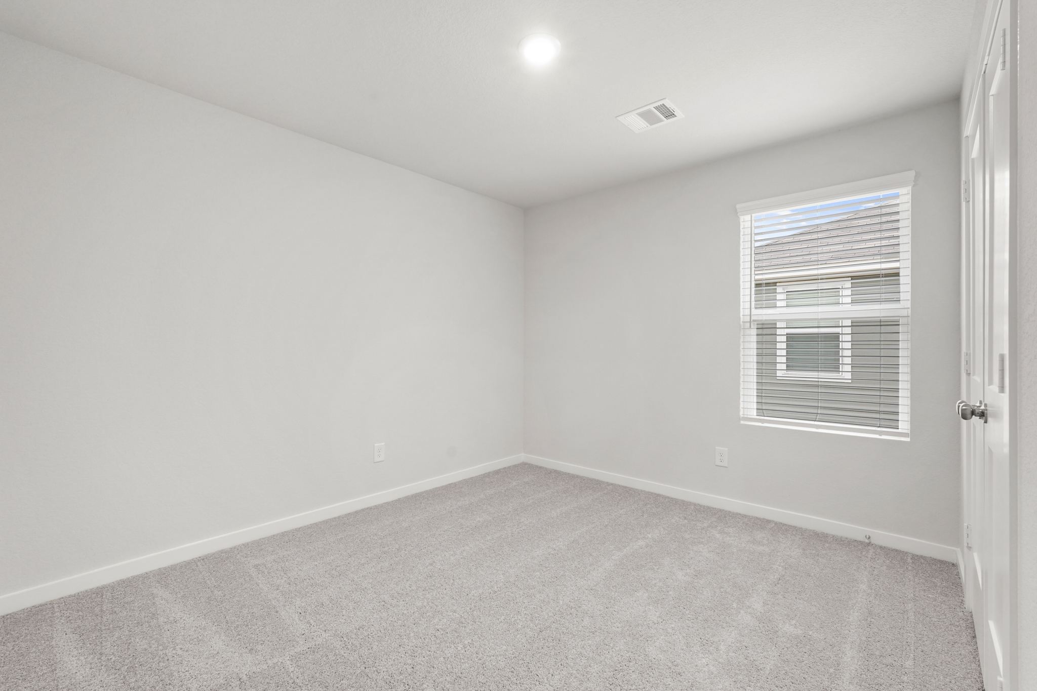 A room with a window and a door.