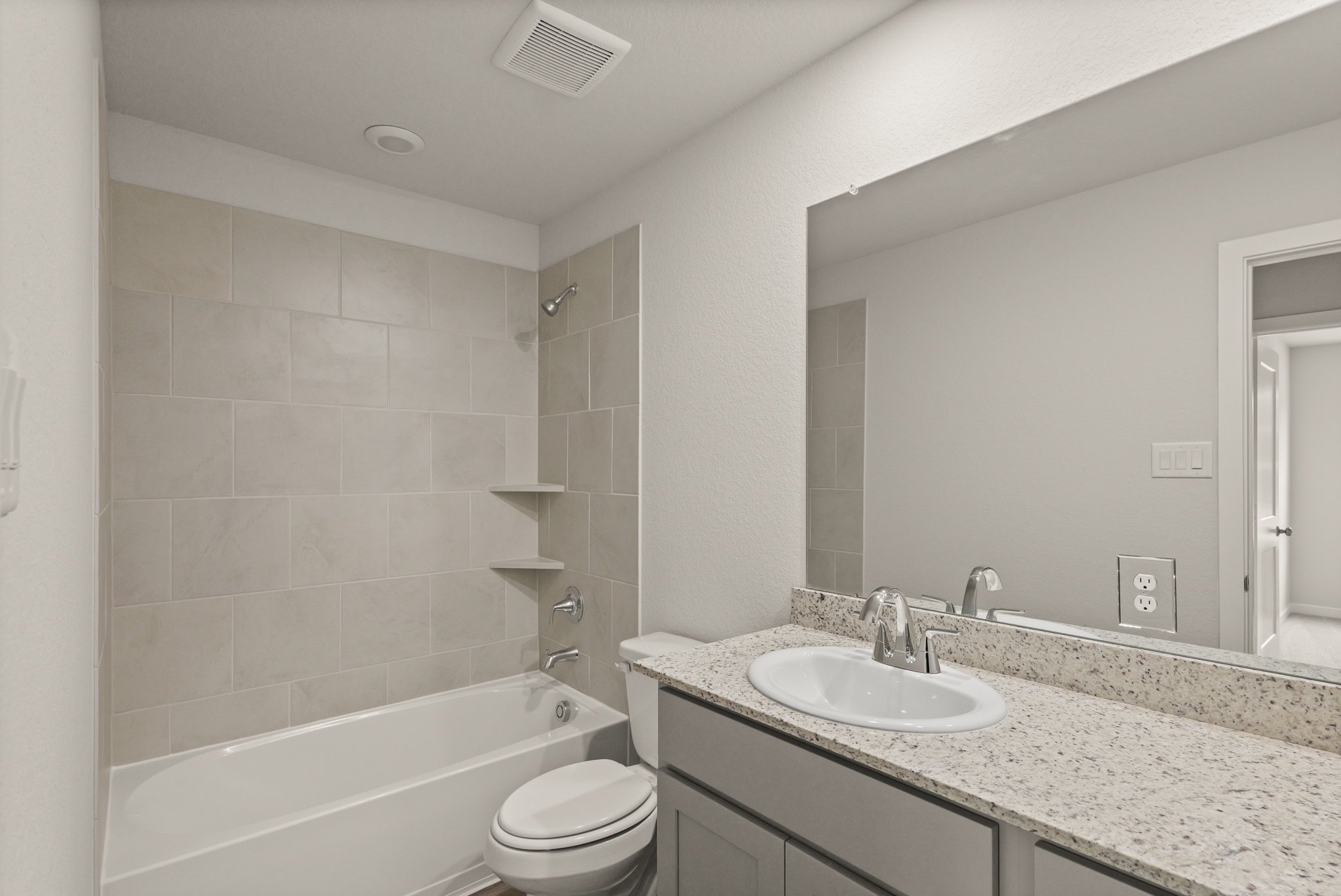 A bathroom with a marble countertop.