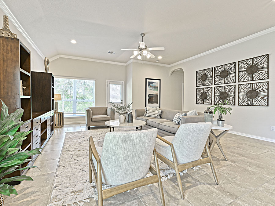 A living room with a chandelier and a couch.
