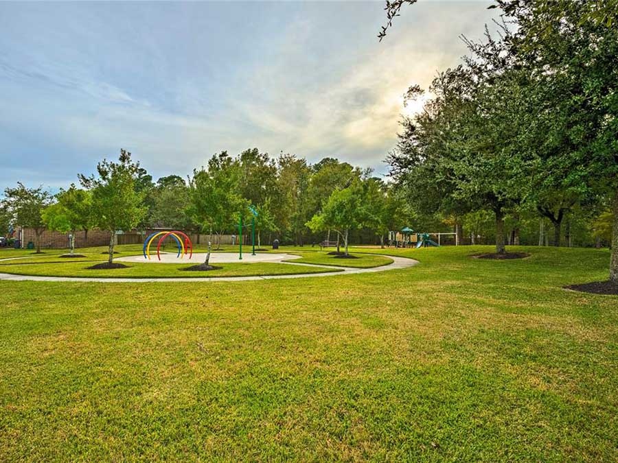 A playground with trees and grass.