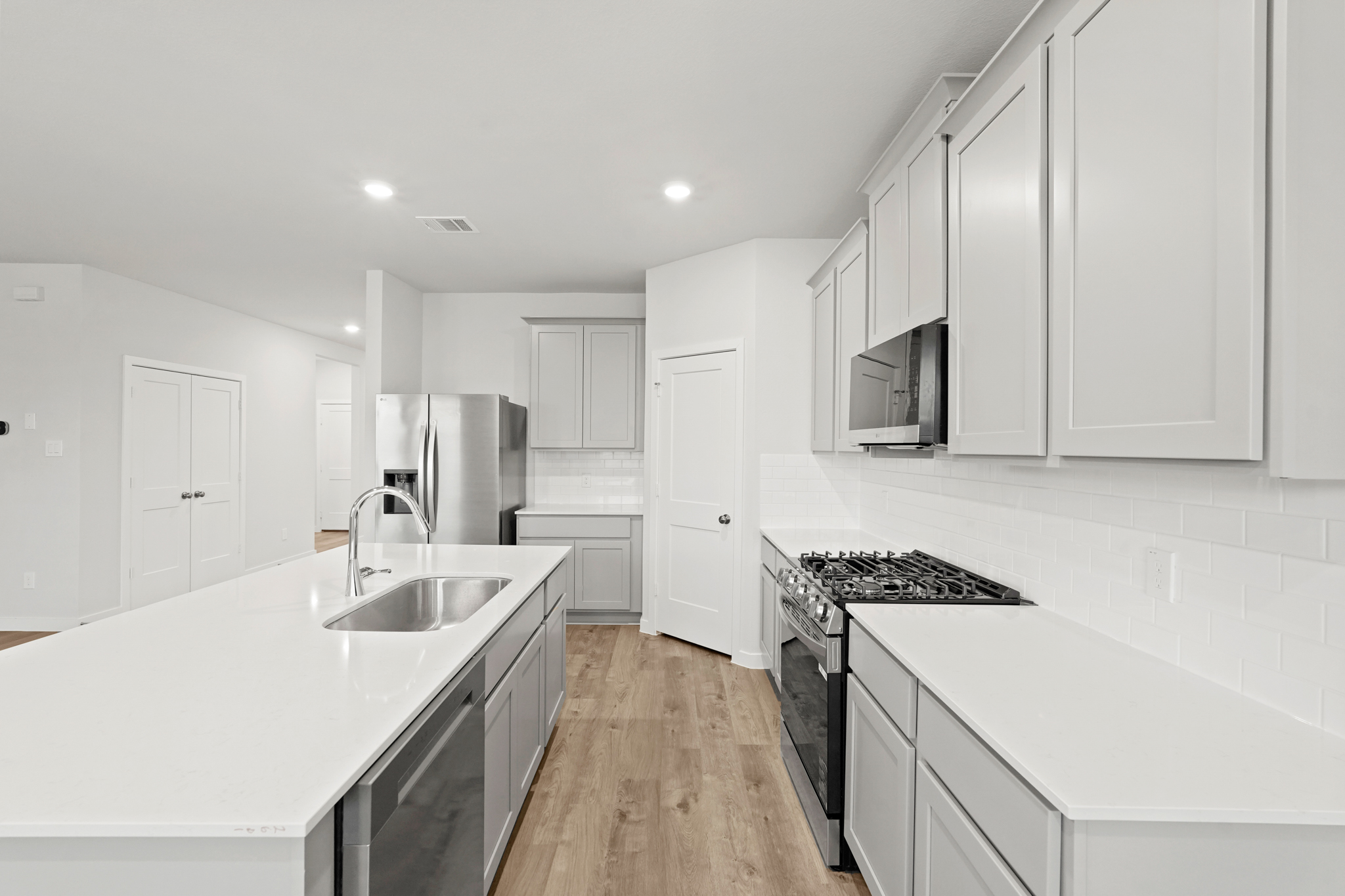 A kitchen with white cabinets.