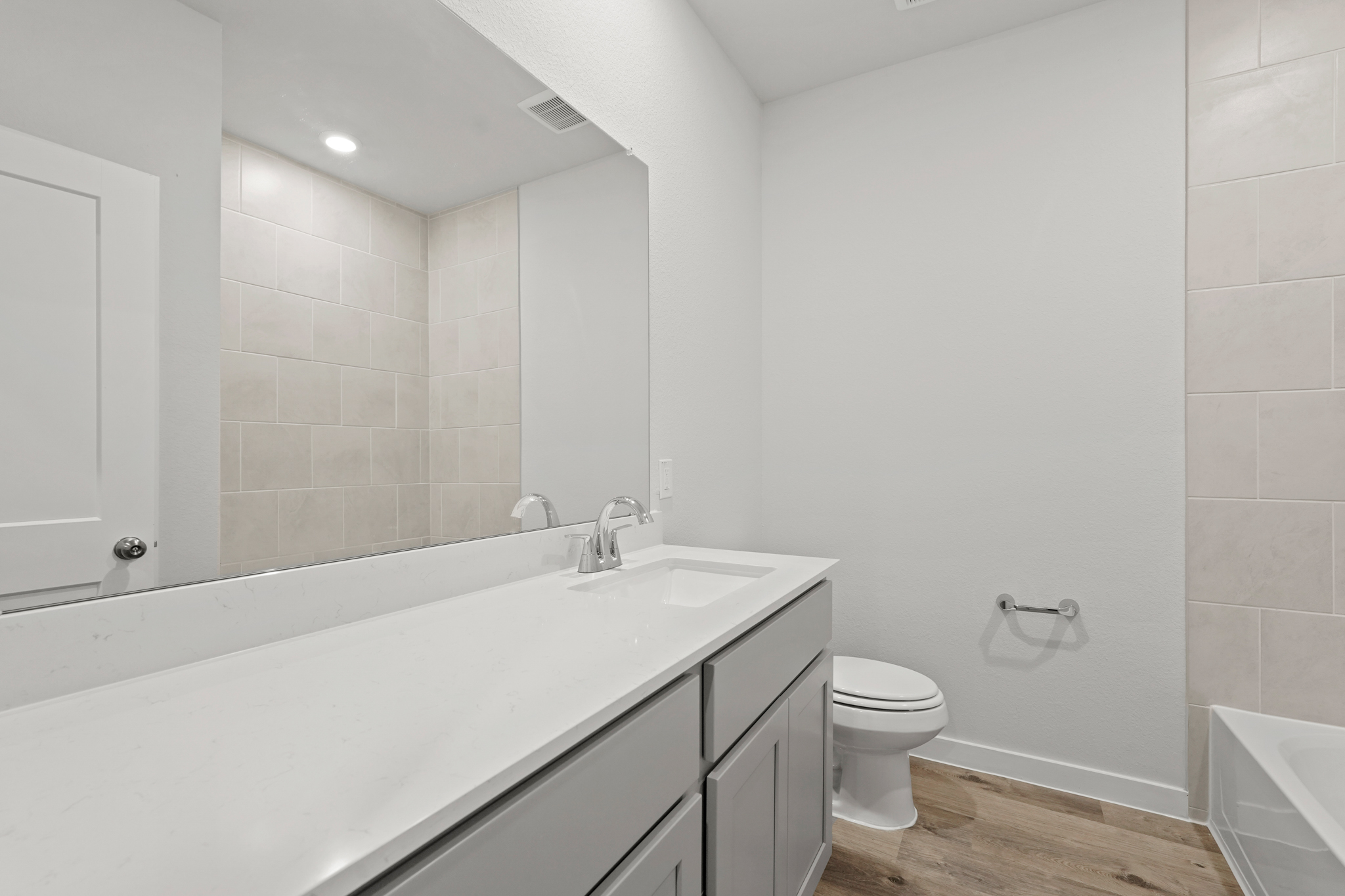 A bathroom with a tub toilet and sink.