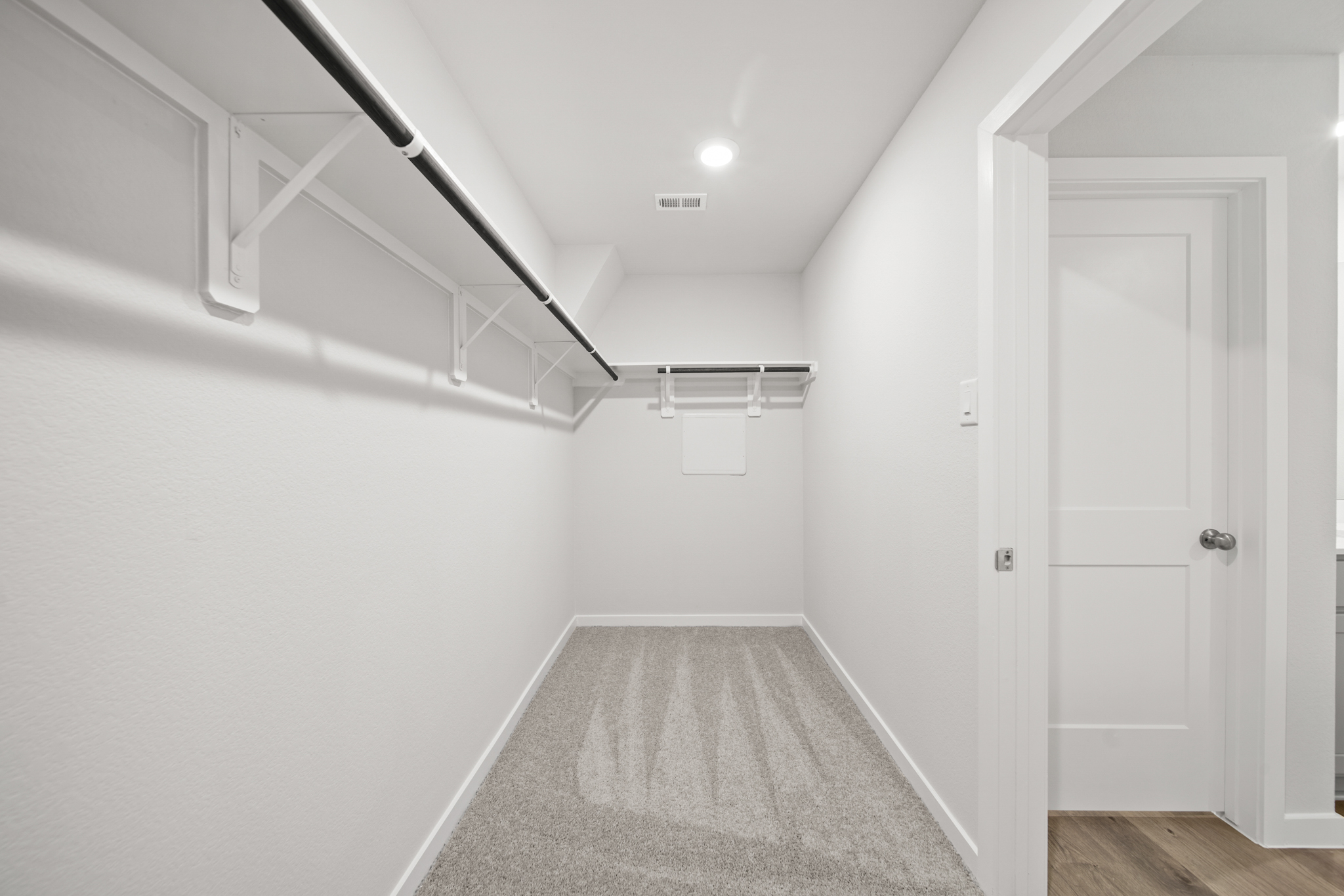 A hallway with white walls.