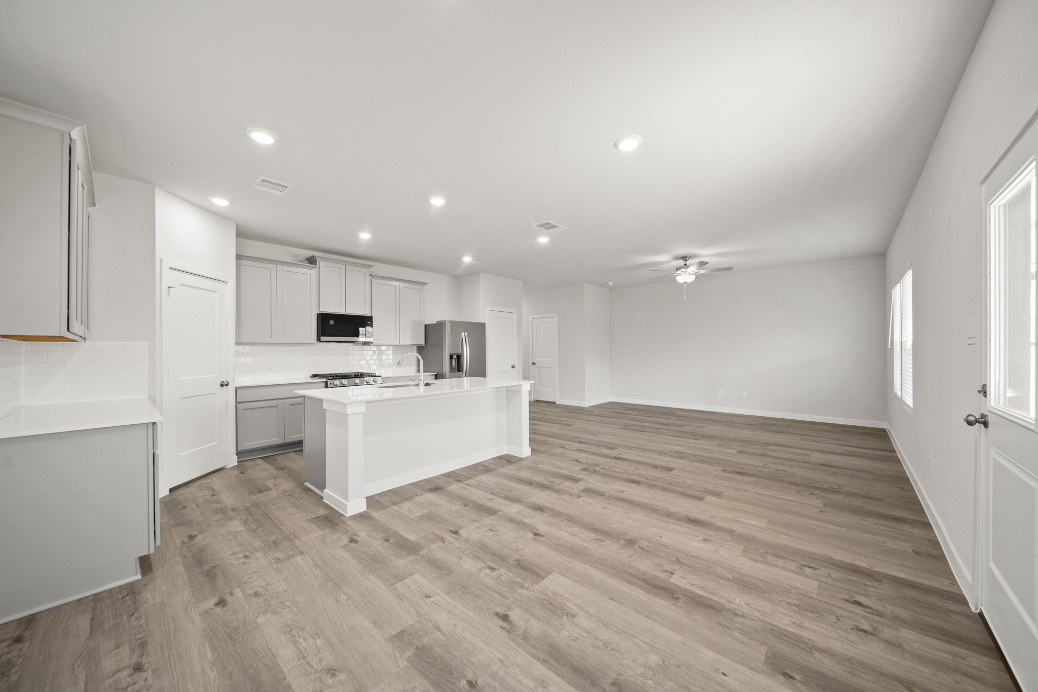 A kitchen with white cabinets.