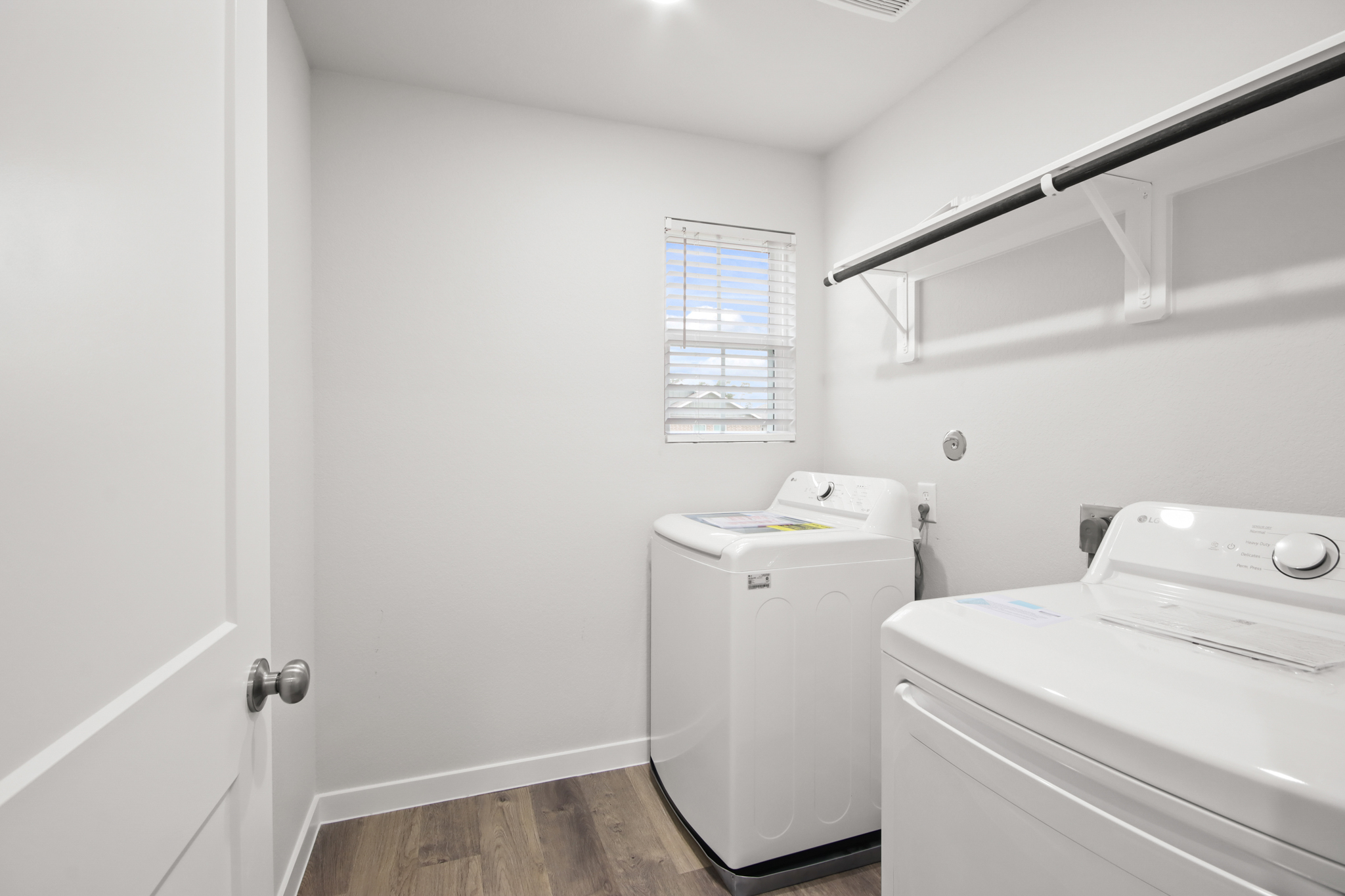 A room with a washer and dryer.