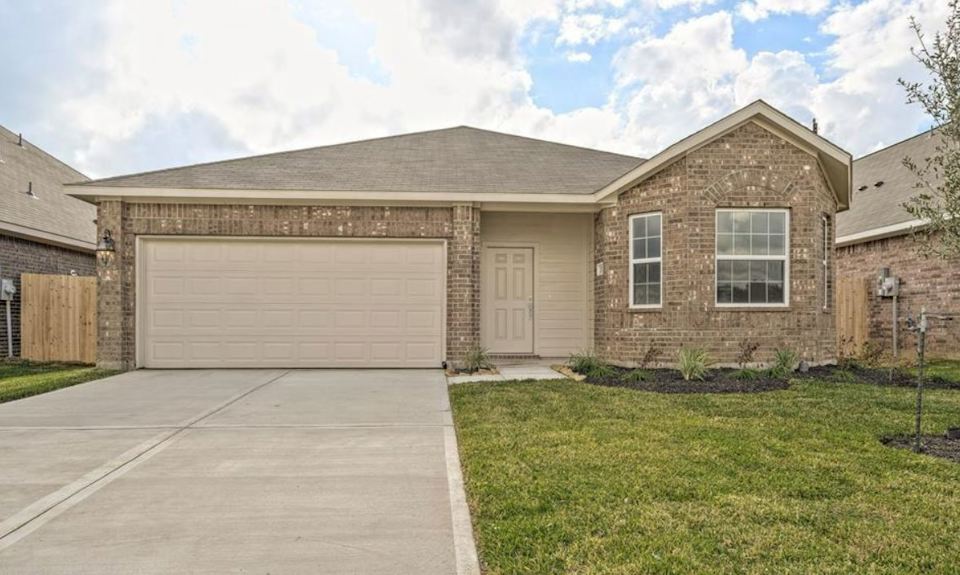 A house with garages and grass.