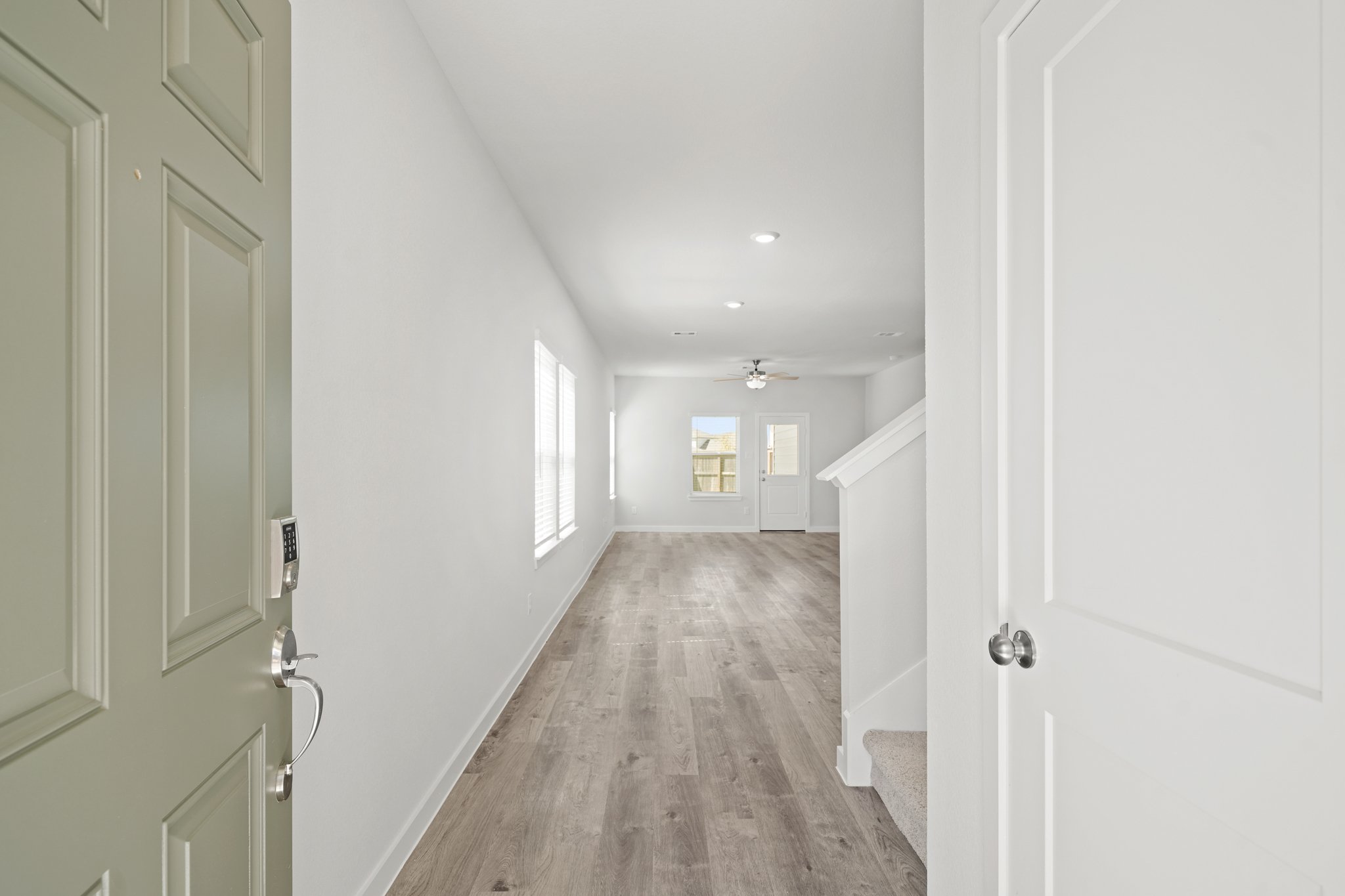 A hallway with white doors.