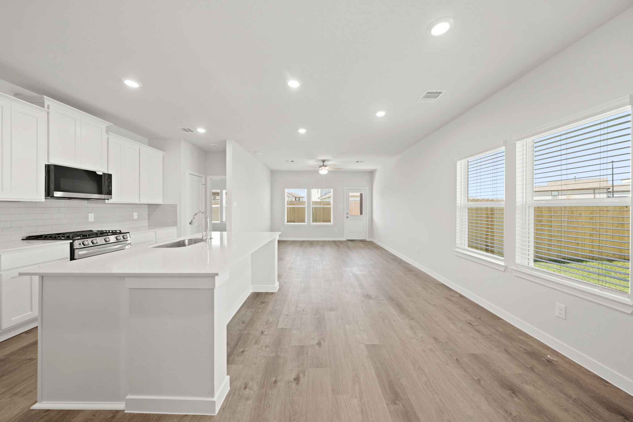 A kitchen with white cabinets.