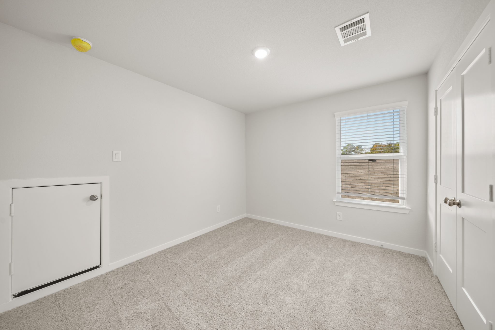 A room with a window and a door.